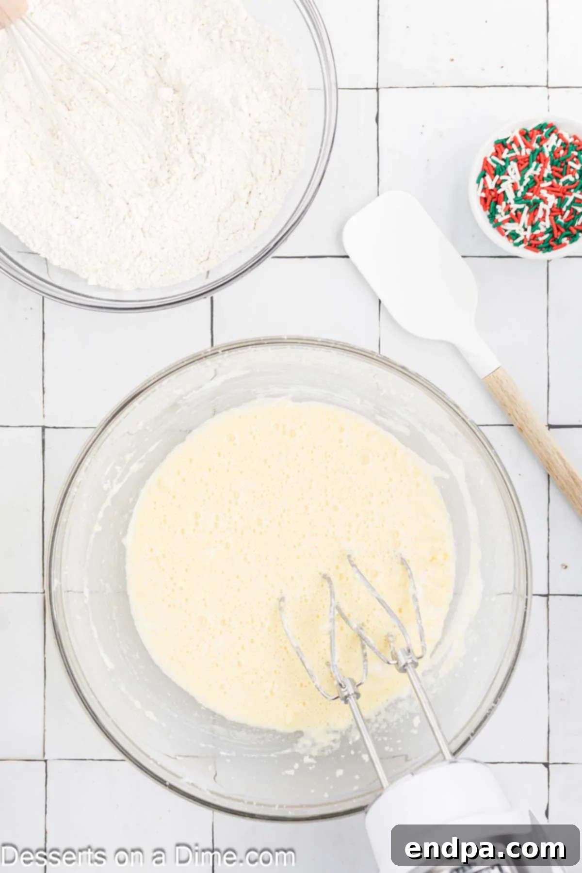 Yuletide Bake 5 Wet ingredients including milk, sour cream, and vanilla extract being added to the creamed butter and sugar mixture in a bowl.