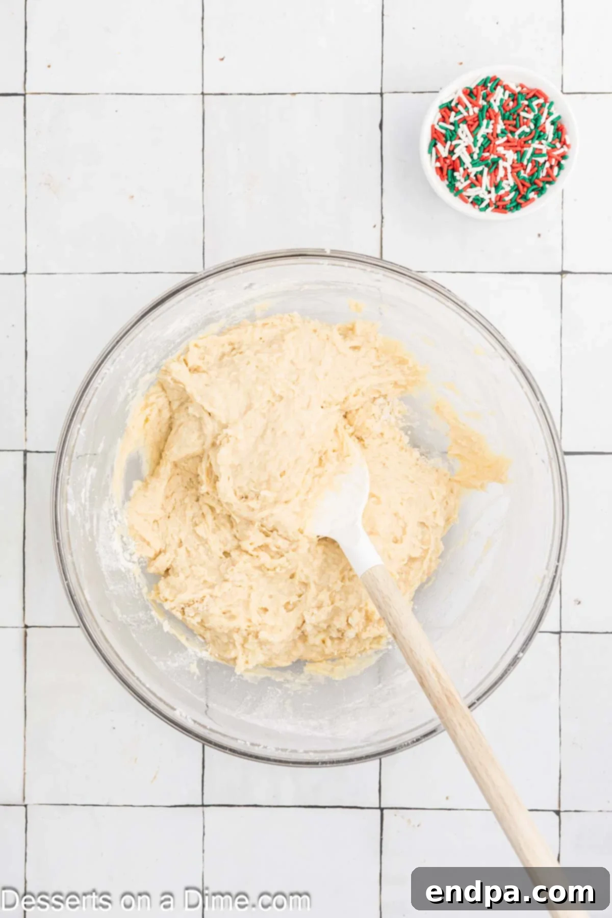 Yuletide Bake 6 The whisked flour mixture being gently folded into the wet ingredients with a spatula in a large mixing bowl, ensuring no lumps.