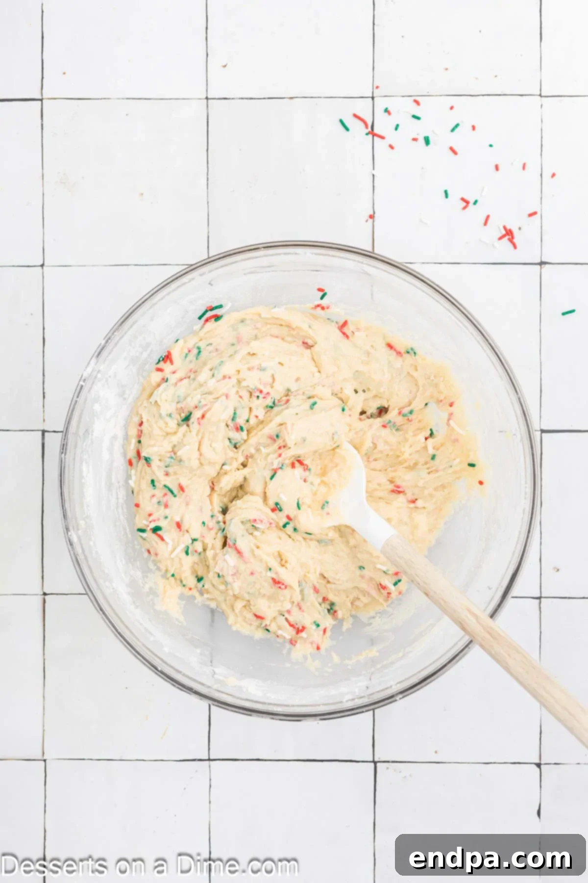 Yuletide Bake 7 Colorful Christmas sprinkles being carefully stirred into the bread dough in a bowl, avoiding overmixing.