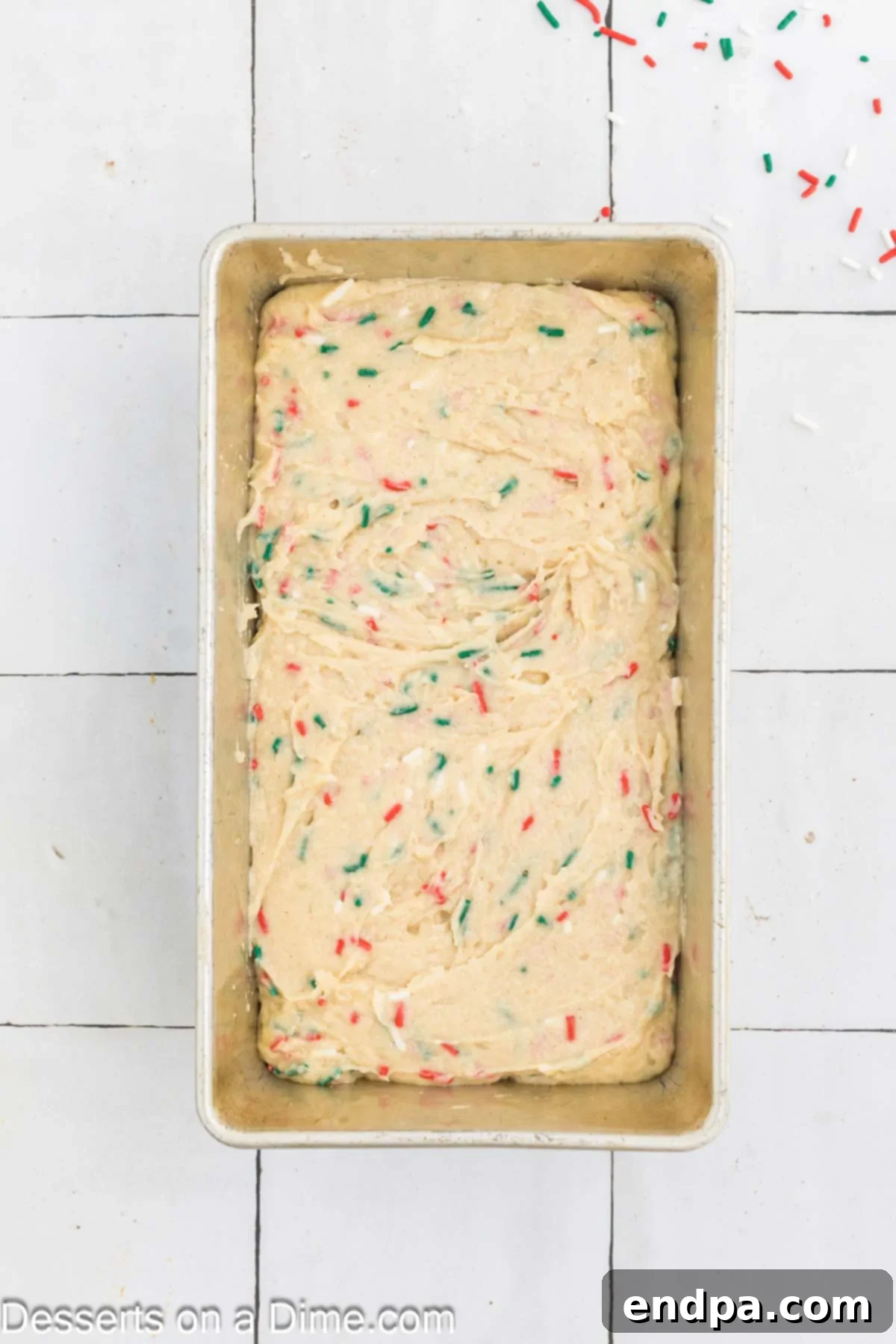 Yuletide Bake 8 Christmas bread batter poured evenly into a prepared loaf pan, ready for the oven.