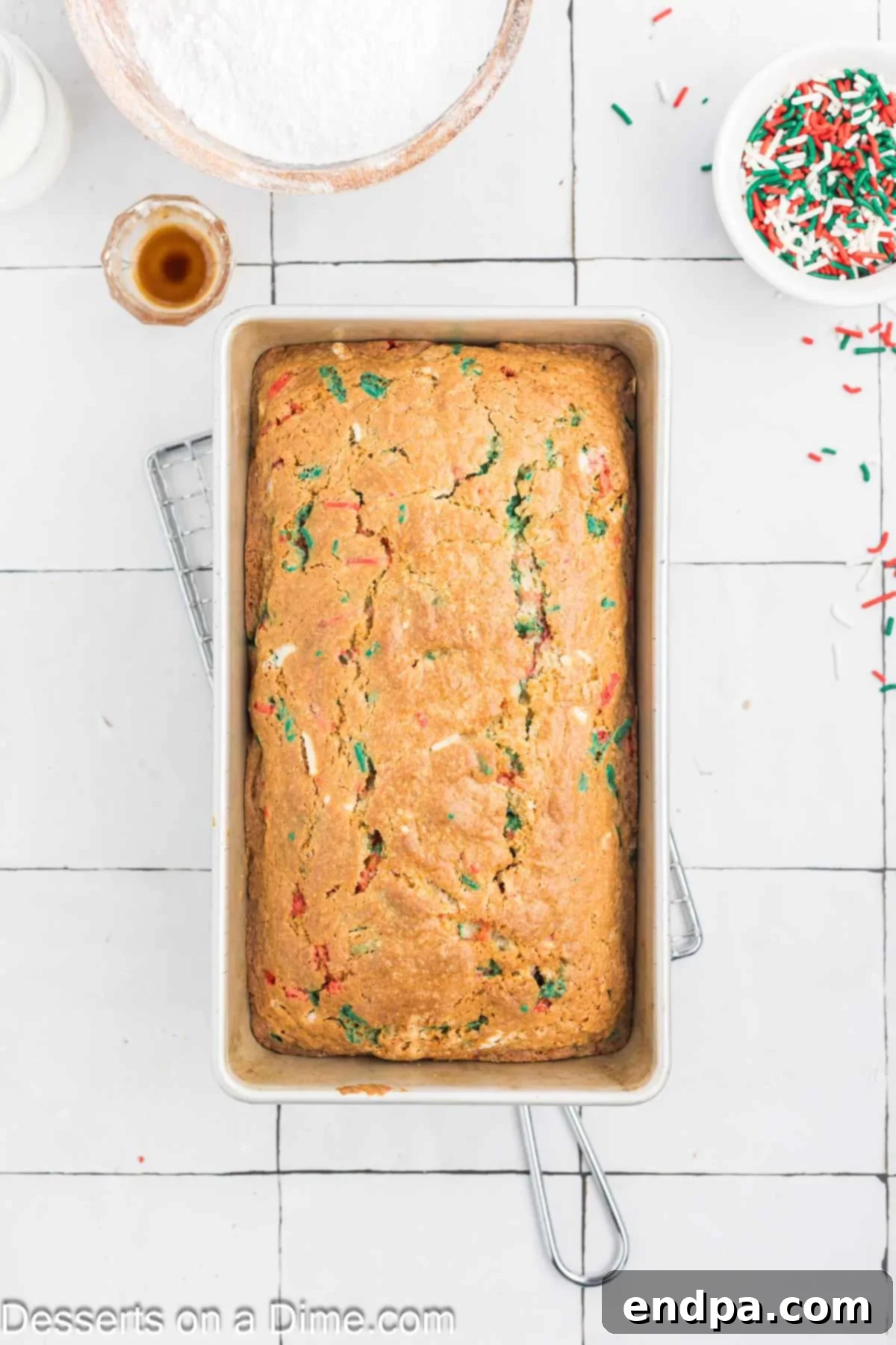 Yuletide Bake 9 A golden brown, perfectly baked Christmas Bread loaf cooling in its pan on a wire rack.