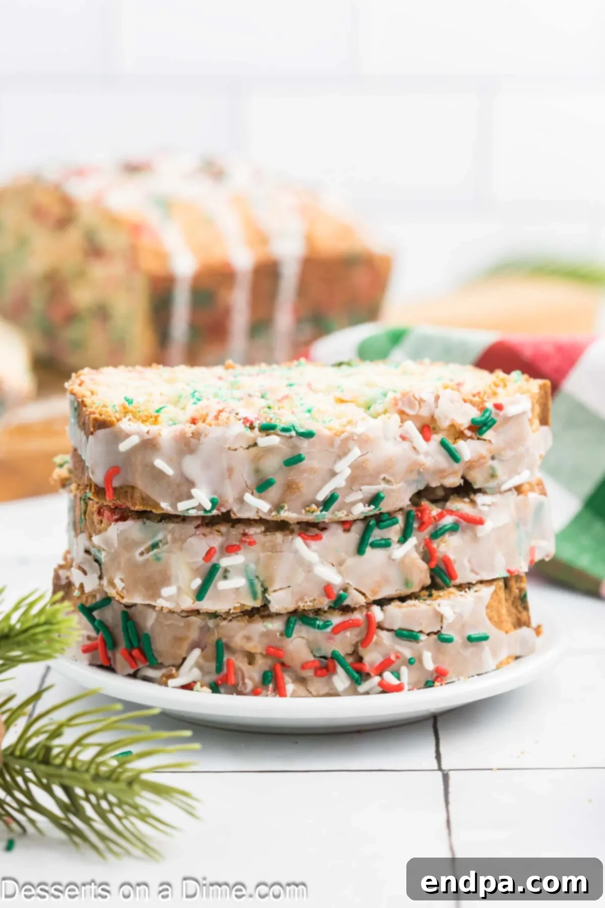 Yuletide Bake 10 Slices of glazed Christmas Bread with sprinkles arranged on a white plate, ready to be served and enjoyed as a holiday treat.