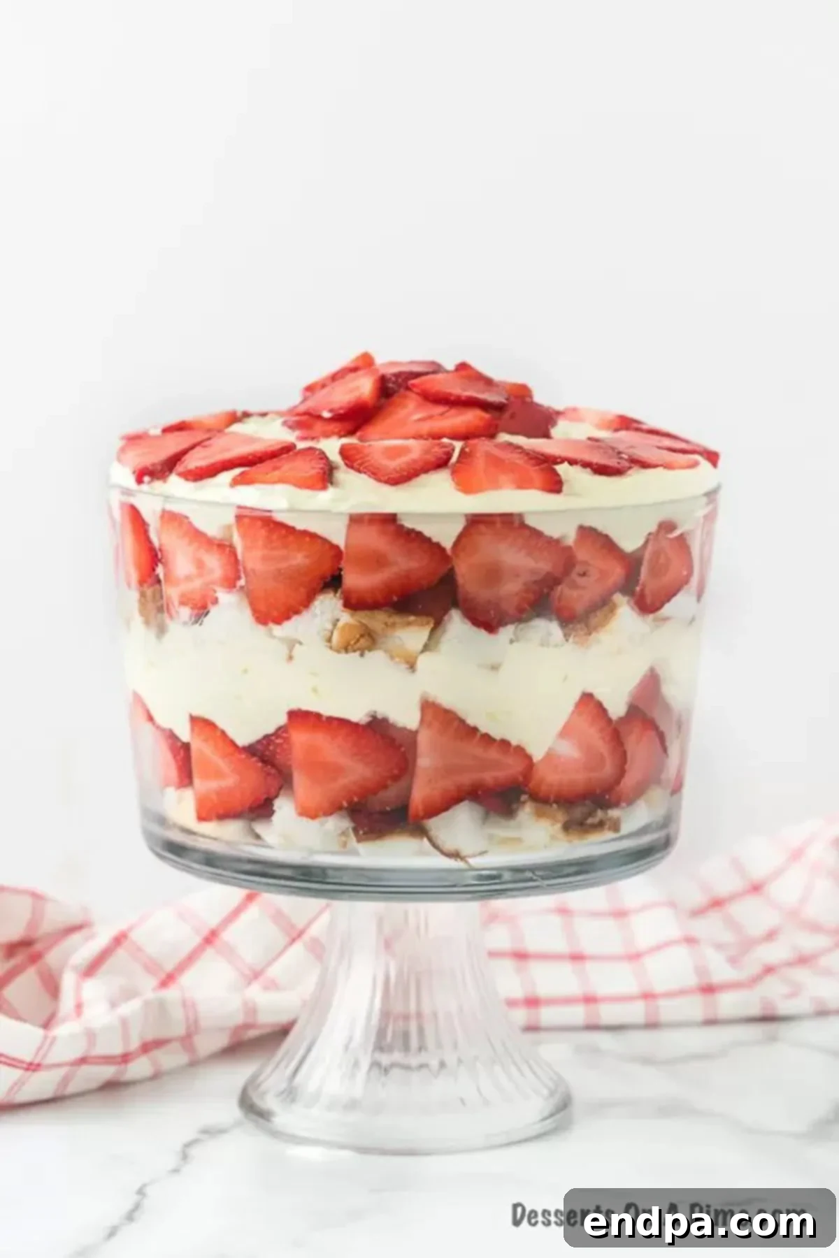 Layers of angel food cake, pudding, strawberries and more make this delicious Strawberry trifle recipe. The dessert looks gorgeous! 