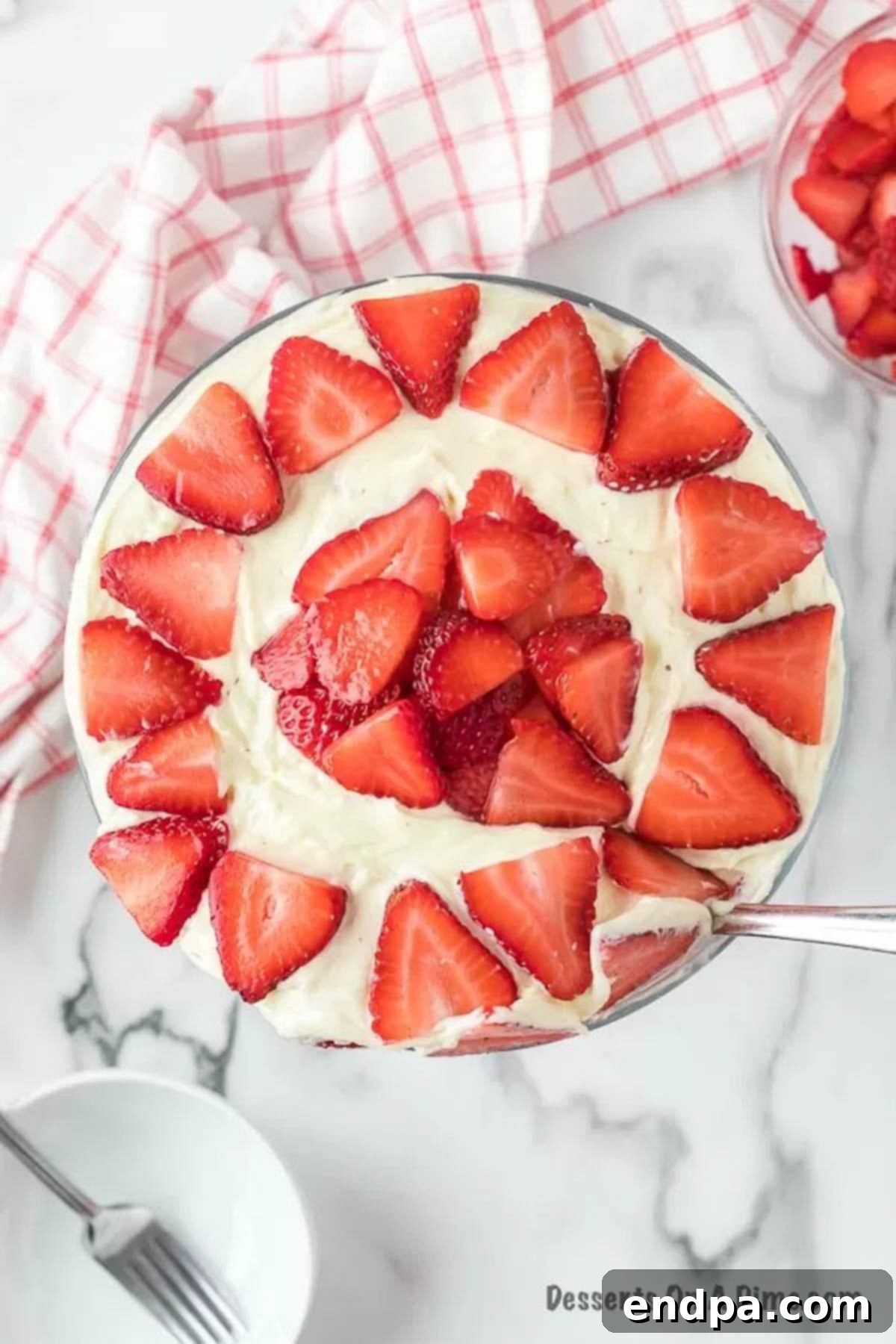 Strawberries arranged on top layer. 