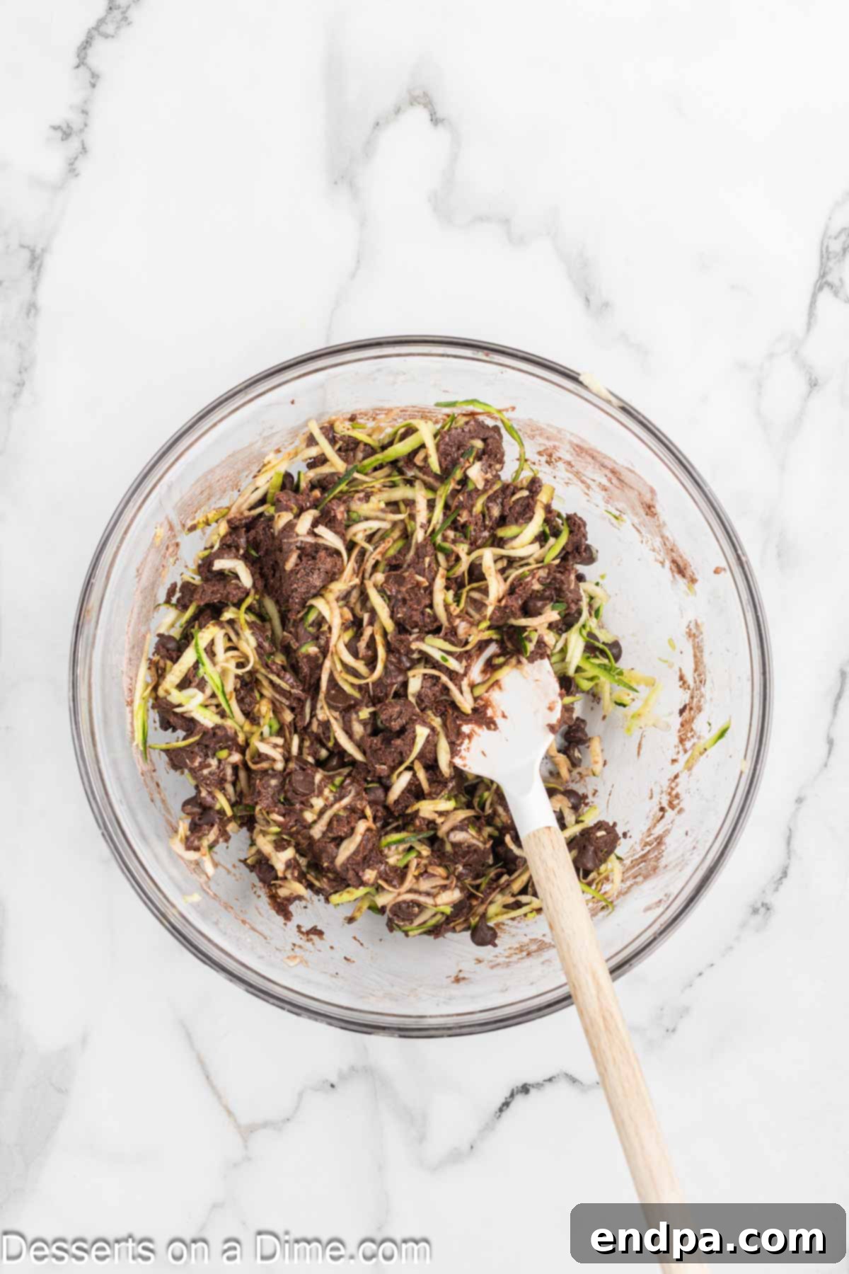 Fudgy Chocolate Zucchini Bread 5 Shredded zucchini being folded into the chocolate bread batter.