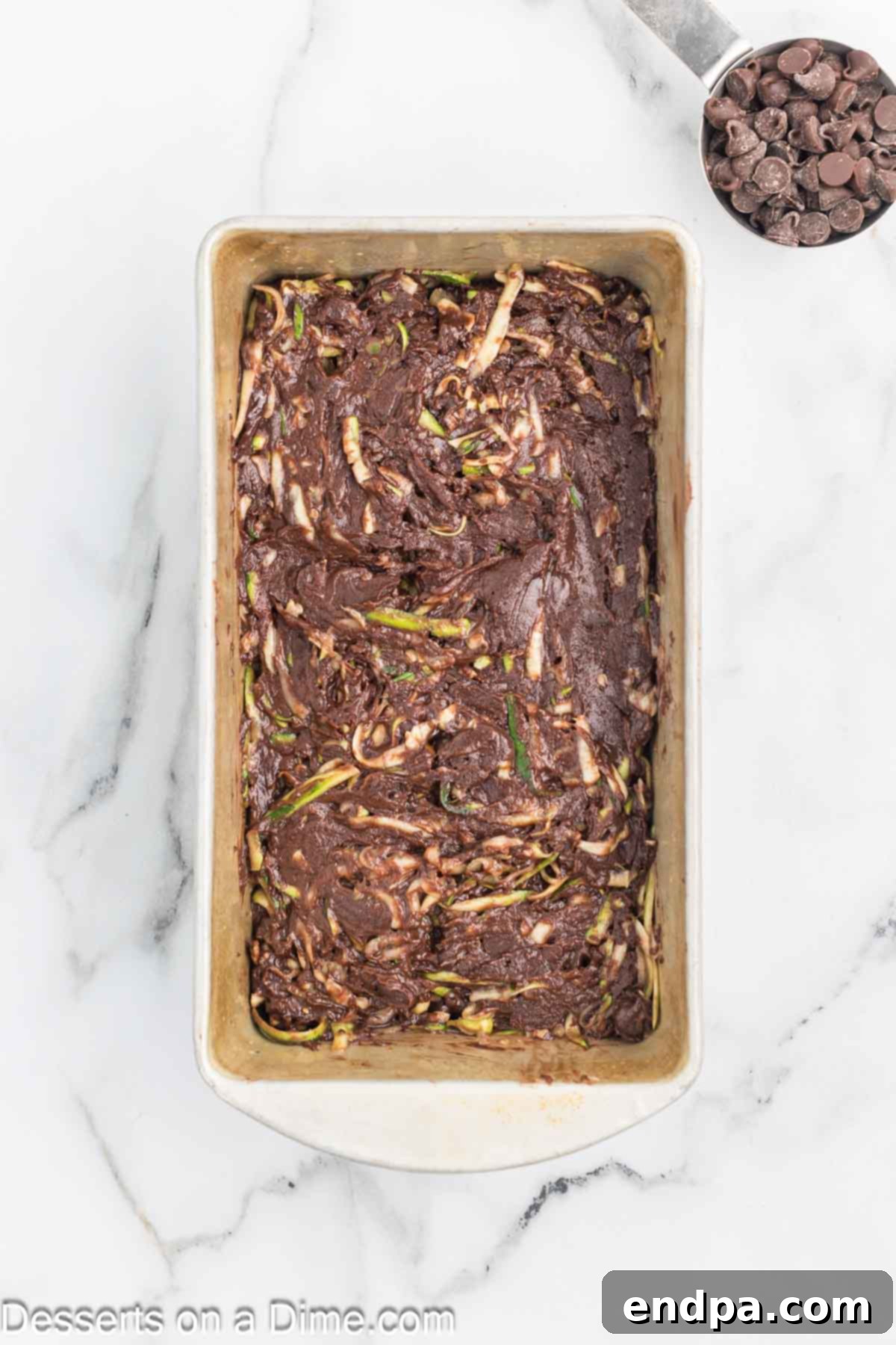 Fudgy Chocolate Zucchini Bread 6 Chocolate zucchini bread batter evenly spread into a loaf pan.