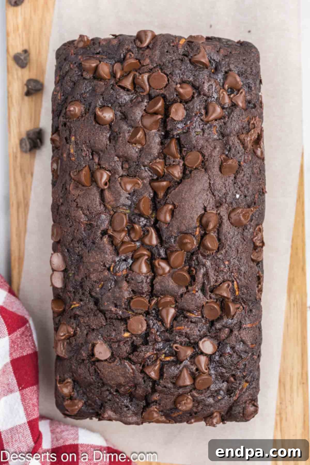 Fudgy Chocolate Zucchini Bread 8 A freshly baked loaf of chocolate zucchini bread, sliced and presented on a plate.