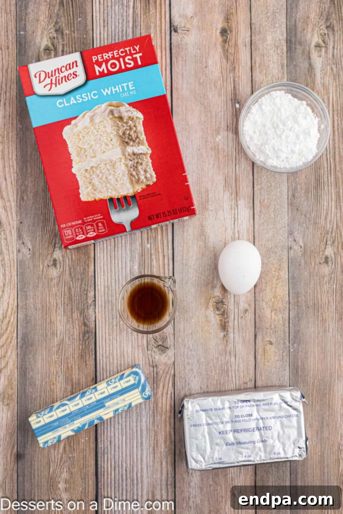 Ingredients for cream cheese cake mix cookies: white cake mix, softened cream cheese, butter, egg, vanilla extract, powdered sugar.