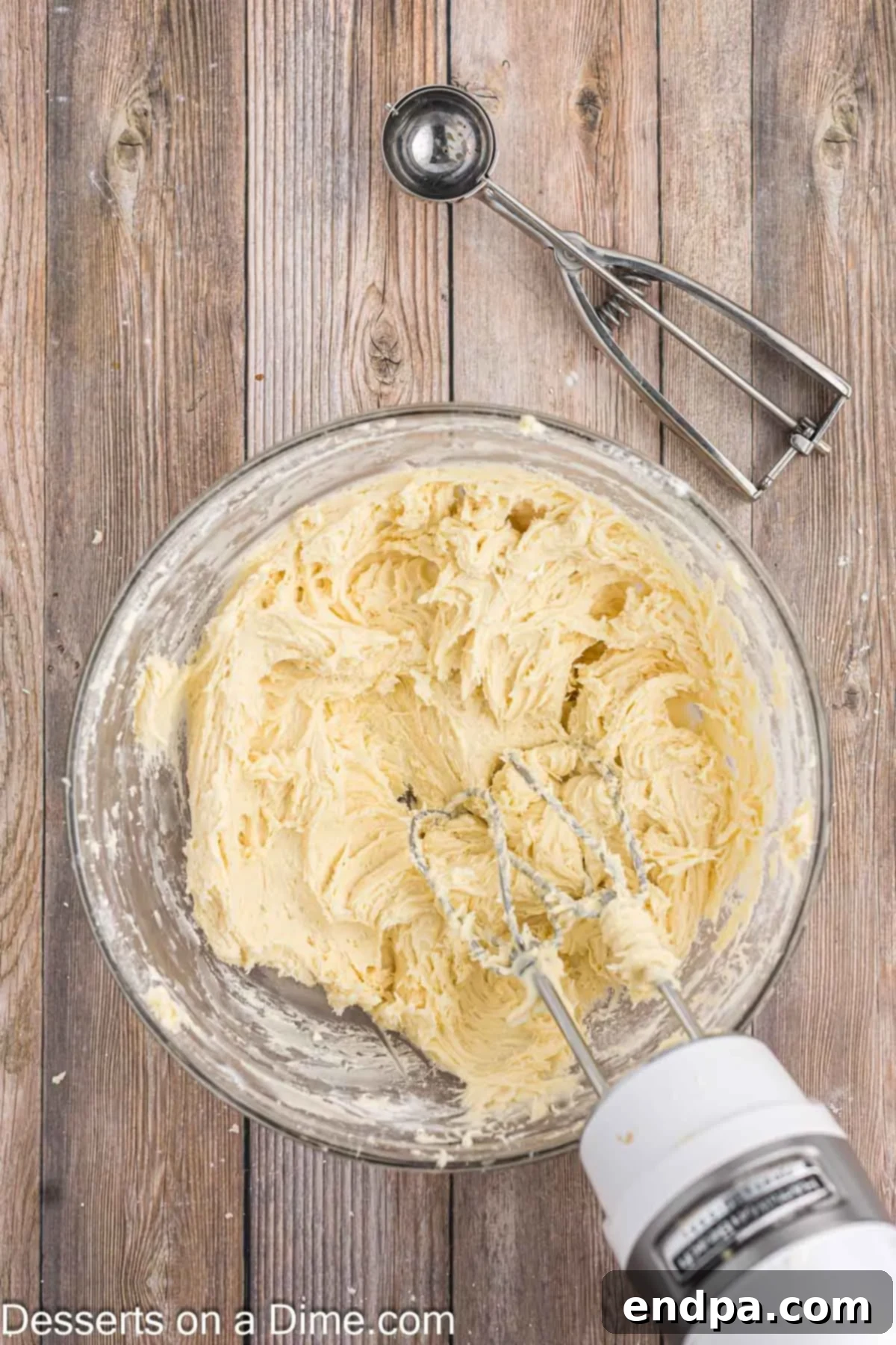 Adding white cake mix to the wet ingredients and mixing until thick.