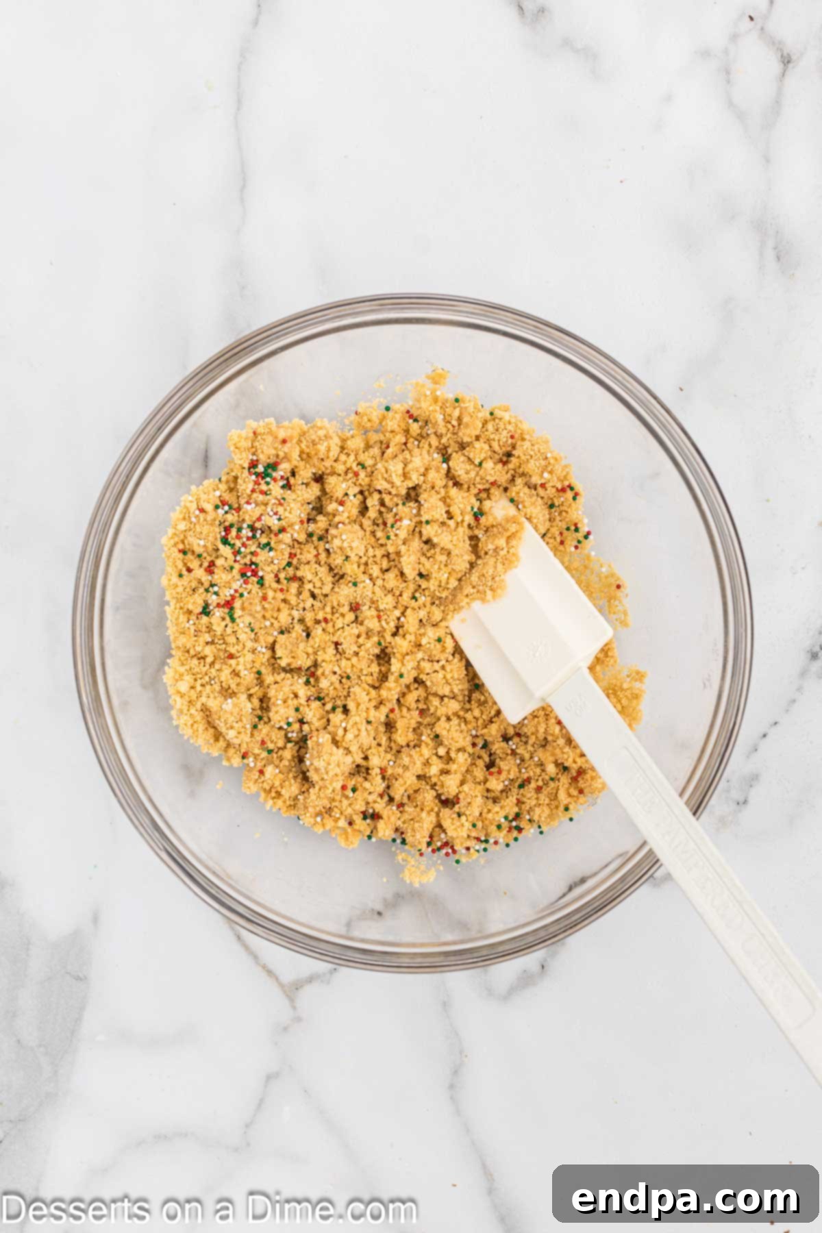 Oreo crumbs combined with butter in a bowl. 
