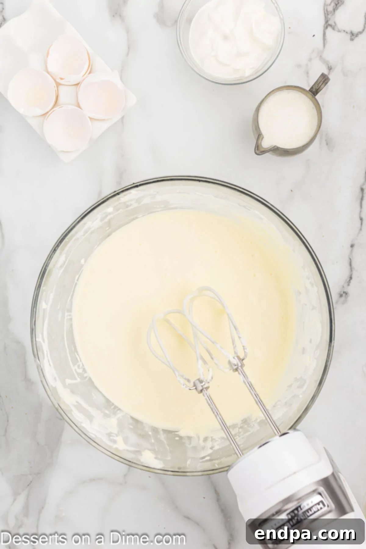 Eggs added into mixture one at a time and combined. 