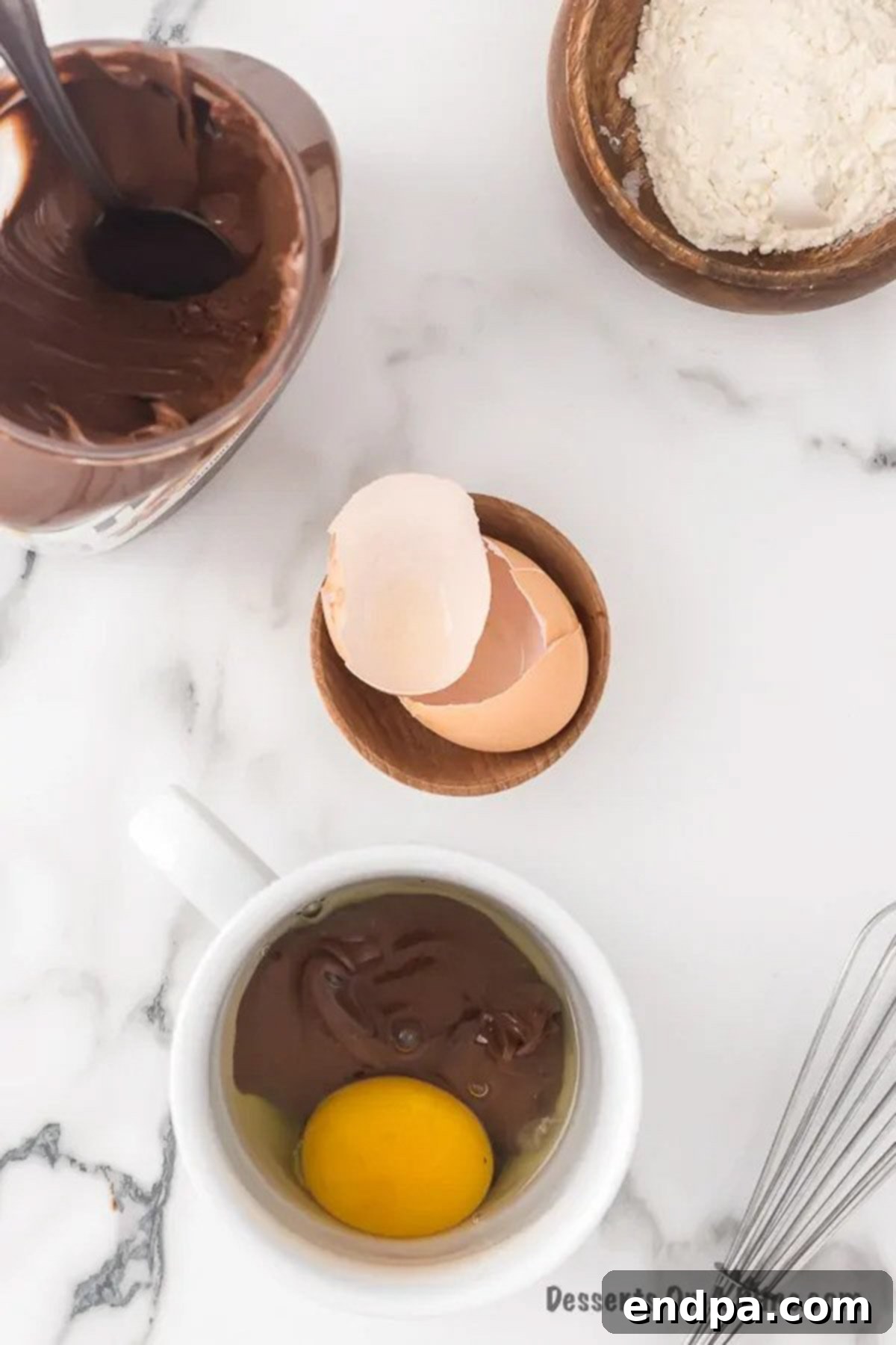 Nutella and an egg added to a microwave-safe mug