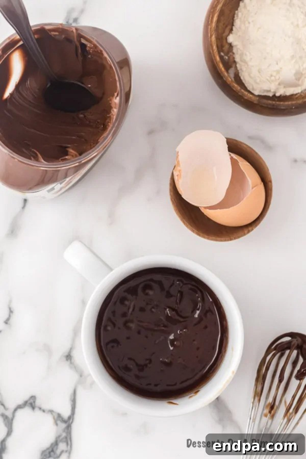 Egg and Nutella being whisked together in a mug