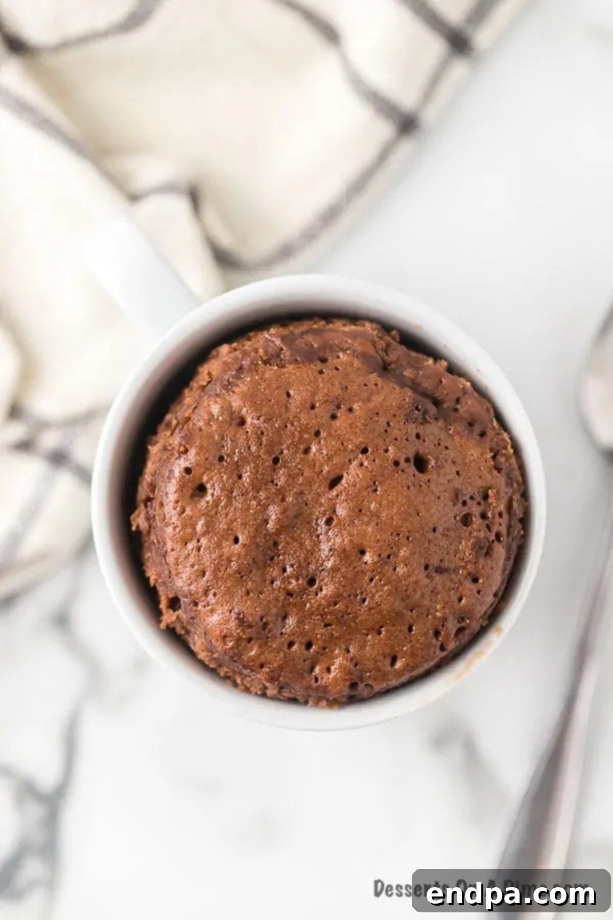 Freshly microwaved Nutella mug cake cooling in the mug