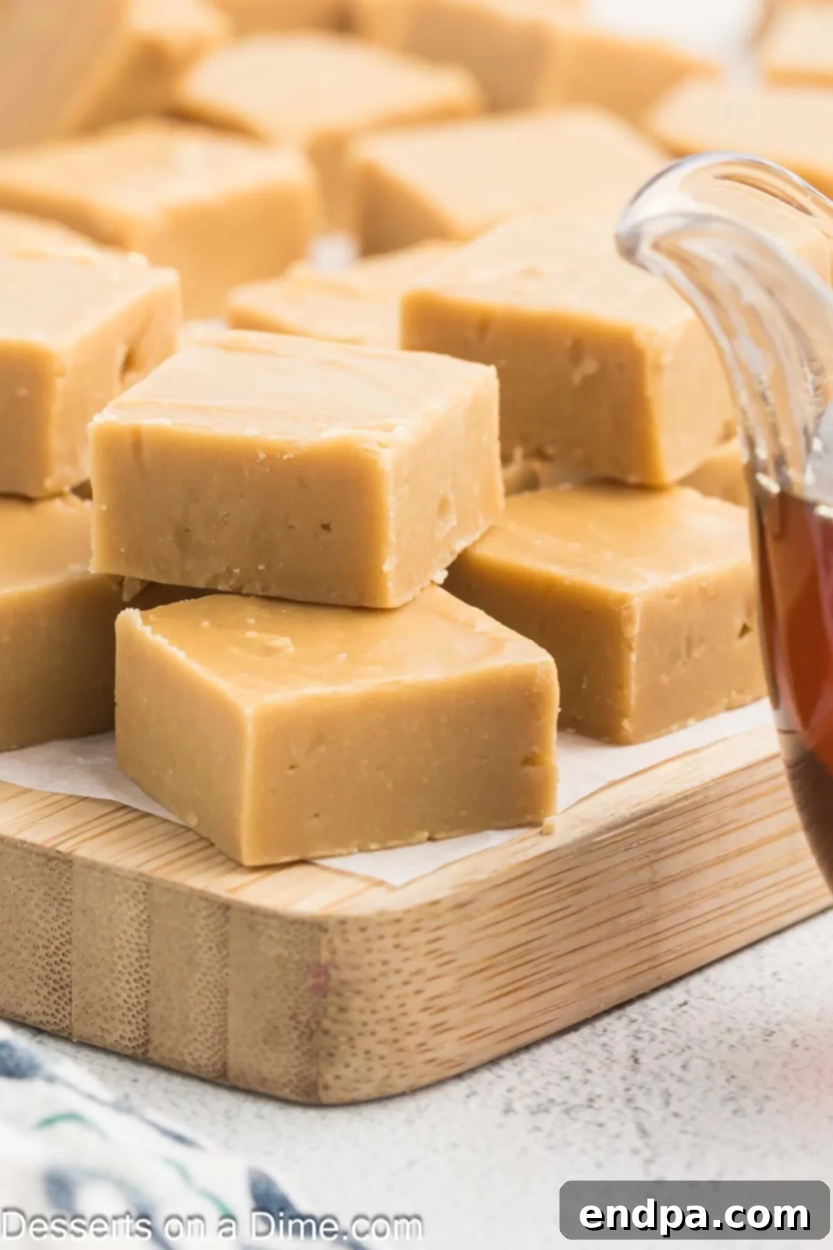 Creamy Maple Fudge 2 Perfectly cut squares of creamy Maple Fudge arranged for serving.