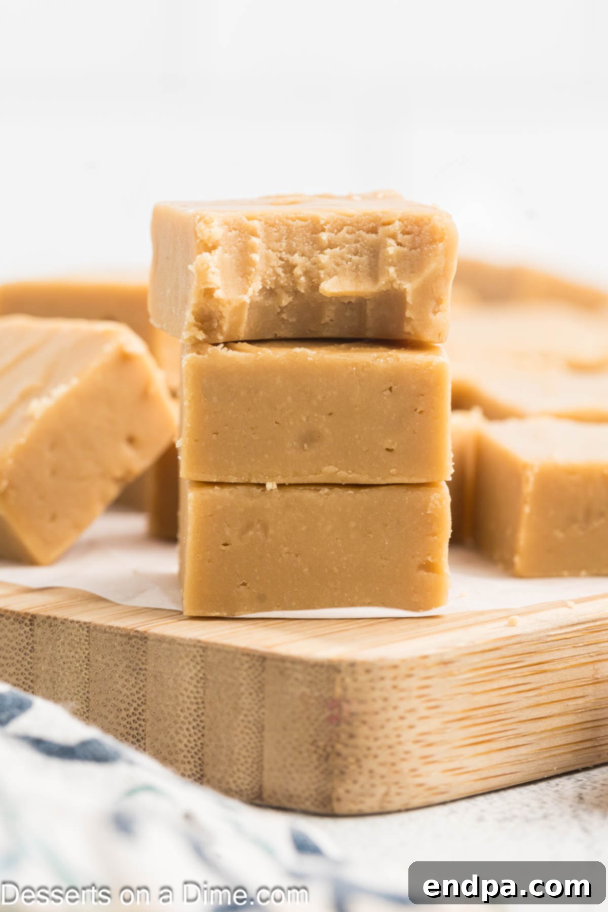 Creamy Maple Fudge 11 Stacked pieces of delicious maple fudge, showcasing its smooth texture.