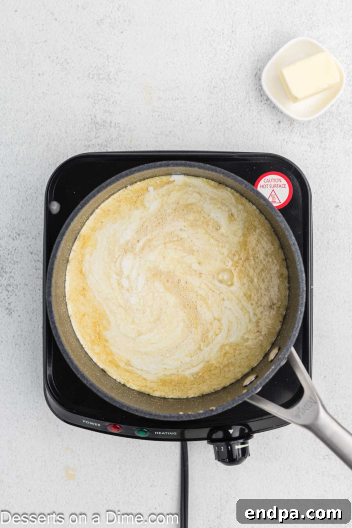 Creamy Maple Fudge 5 Heavy cream being carefully poured into the simmering maple syrup mixture.