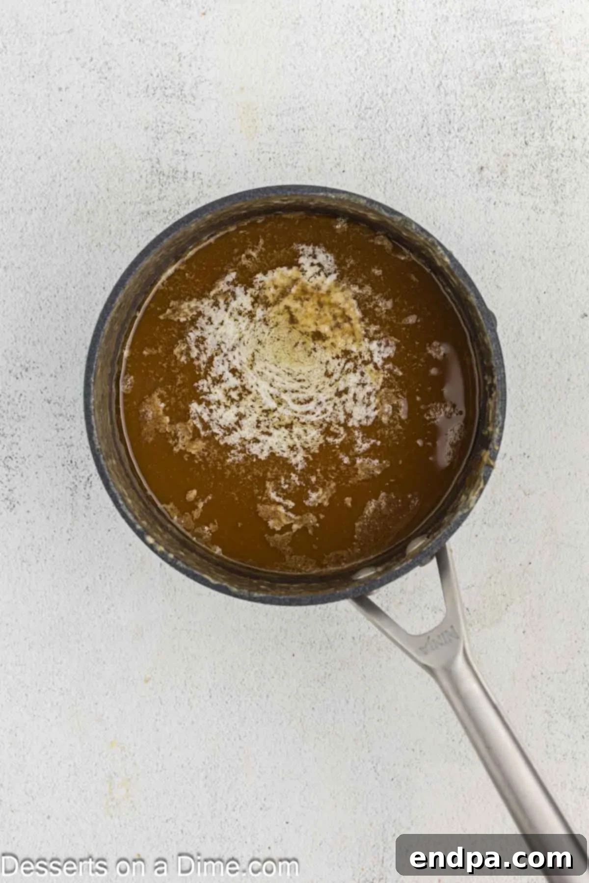 Creamy Maple Fudge 7 Butter pieces melting gradually in the hot maple fudge mixture as it cools.