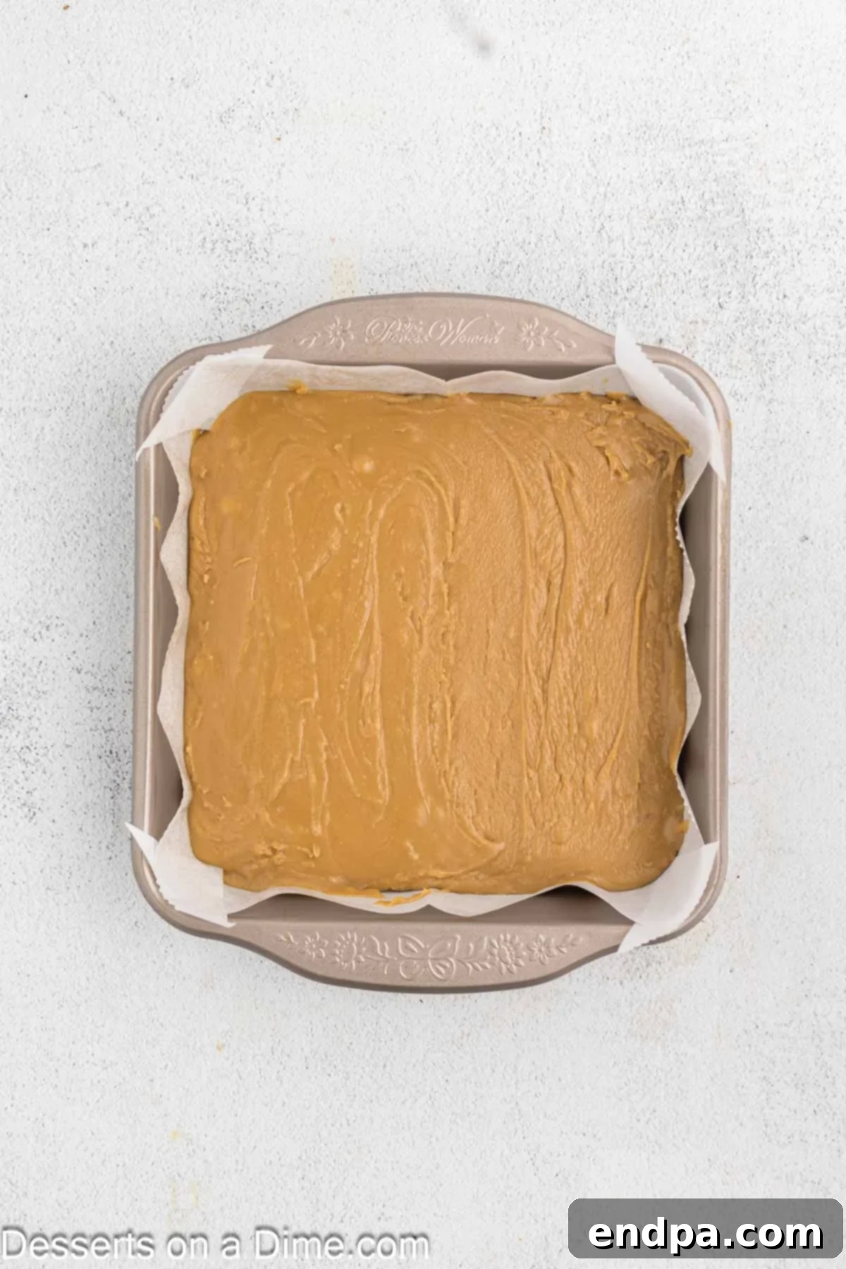 Creamy Maple Fudge 8 The thick and smooth maple fudge mixture being spread evenly into the prepared baking pan.