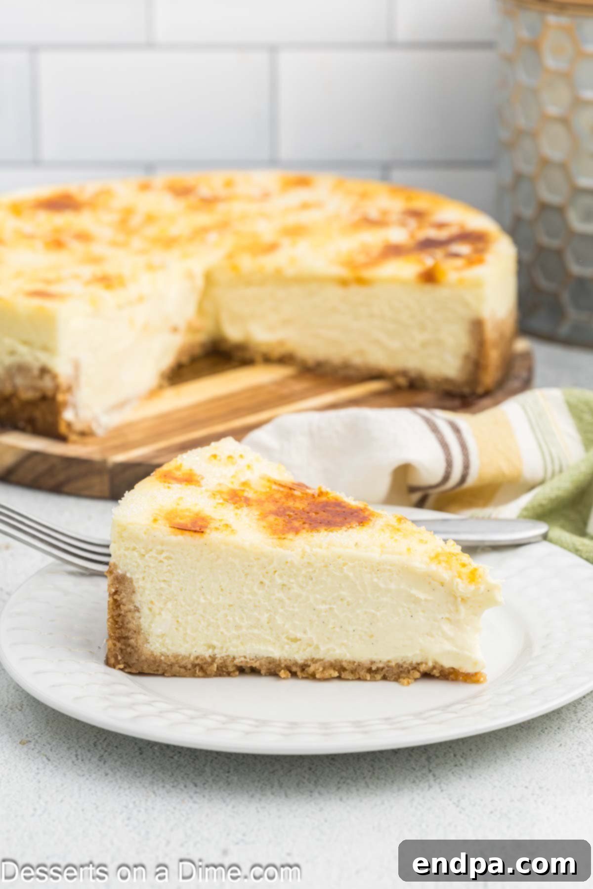 Crispy Caramel Cheesecake 2 A perfectly baked Cheesecake Brulee, being sliced to reveal its creamy texture and the golden caramelized sugar topping.