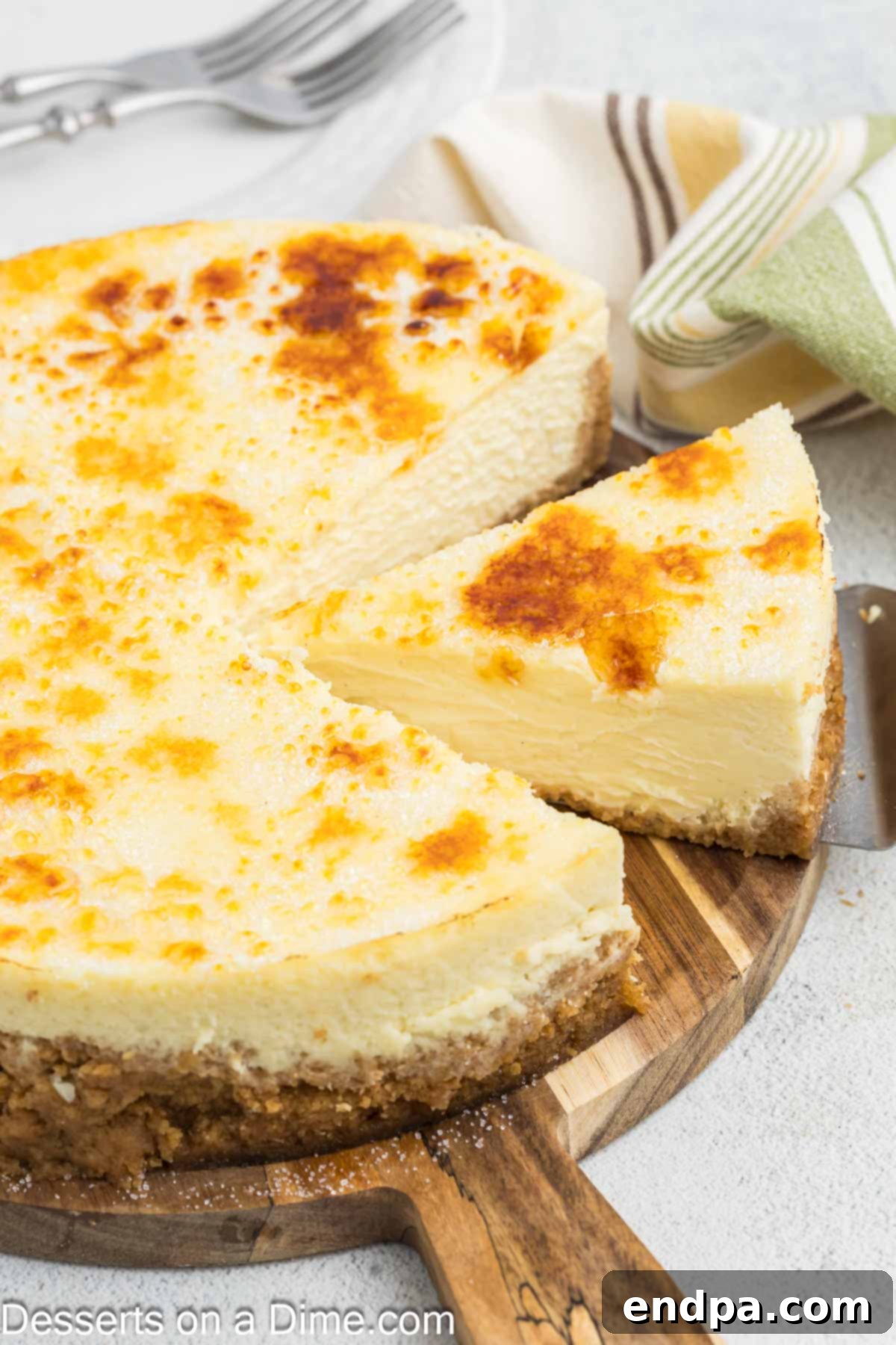 Crispy Caramel Cheesecake 13 A slice of Cheesecake Brulee, revealing the creamy cheesecake filling and the perfectly caramelized sugar topping, ready to be served.