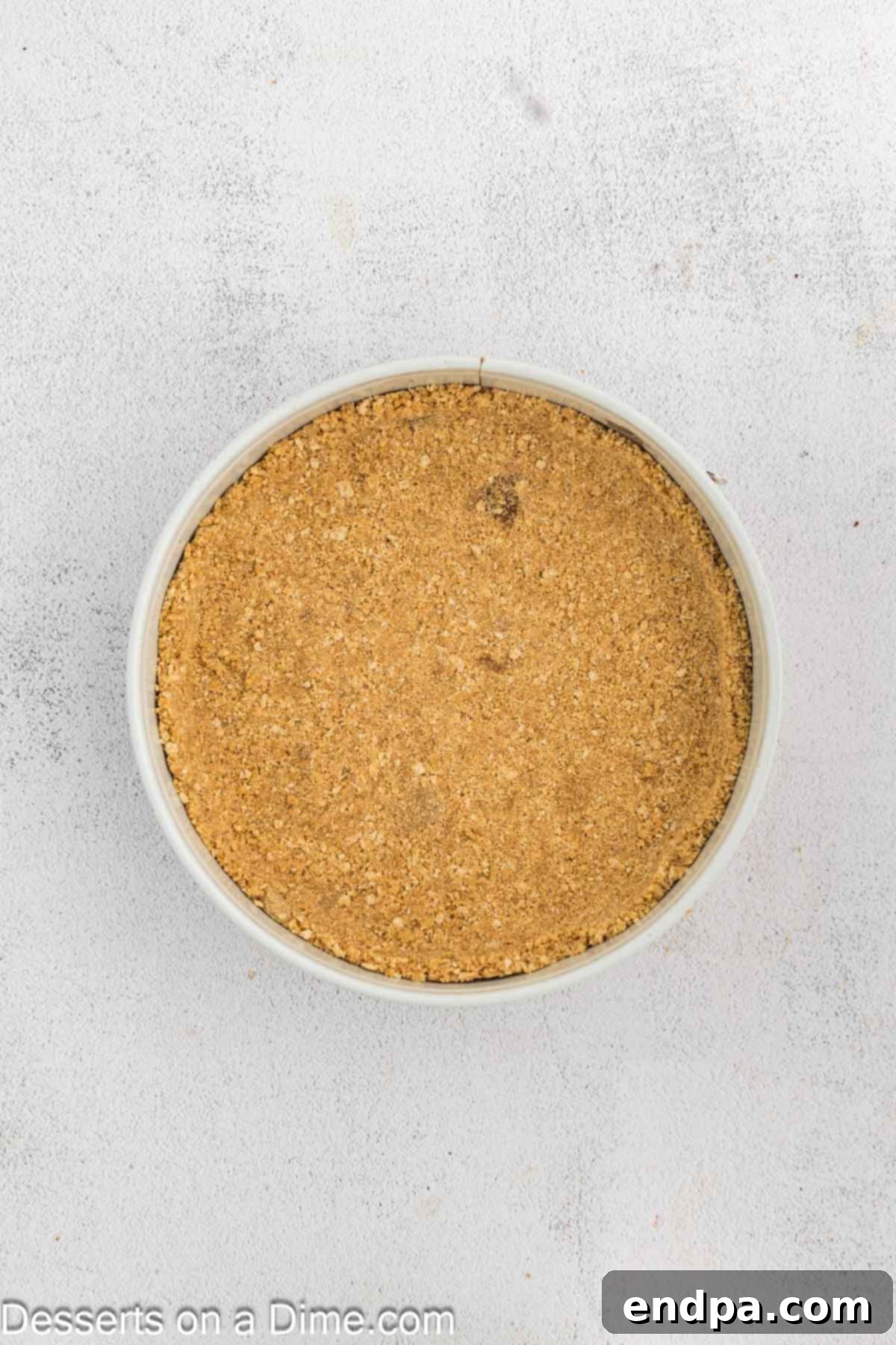 Crispy Caramel Cheesecake 5 The graham cracker crust mixture pressed firmly into the bottom and slightly up the sides of a 9-inch springform pan.