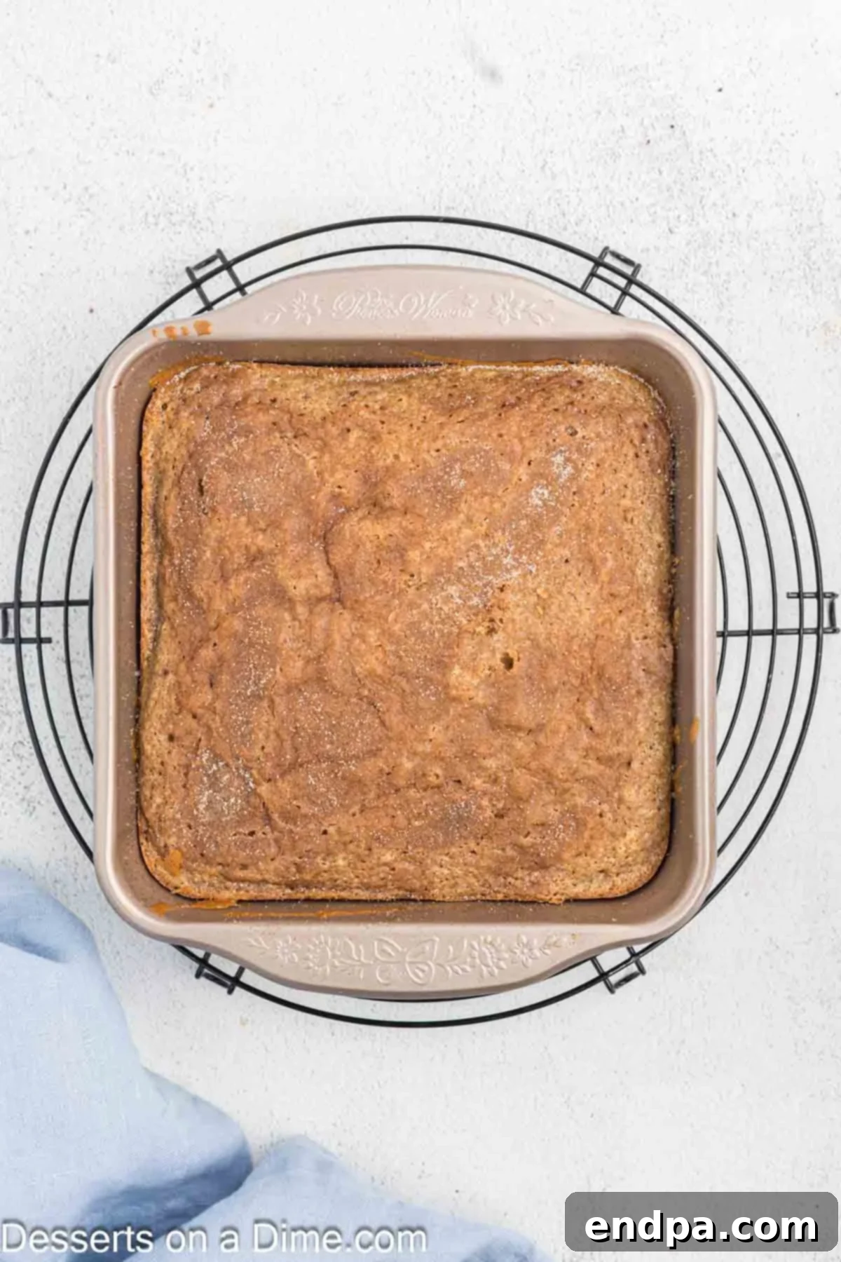 Golden Spiced Churro Cake 13 Baked Churro Cake cooling on a wire rack.