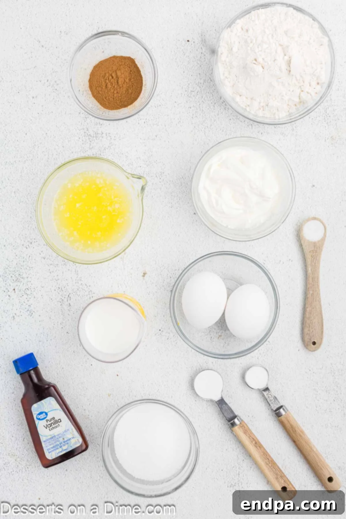 Golden Spiced Churro Cake 3 Ingredients for Churro Cake laid out: all purpose flour, baking soda, butter, cinnamon, sugar, eggs, sour cream, vanilla, milk.