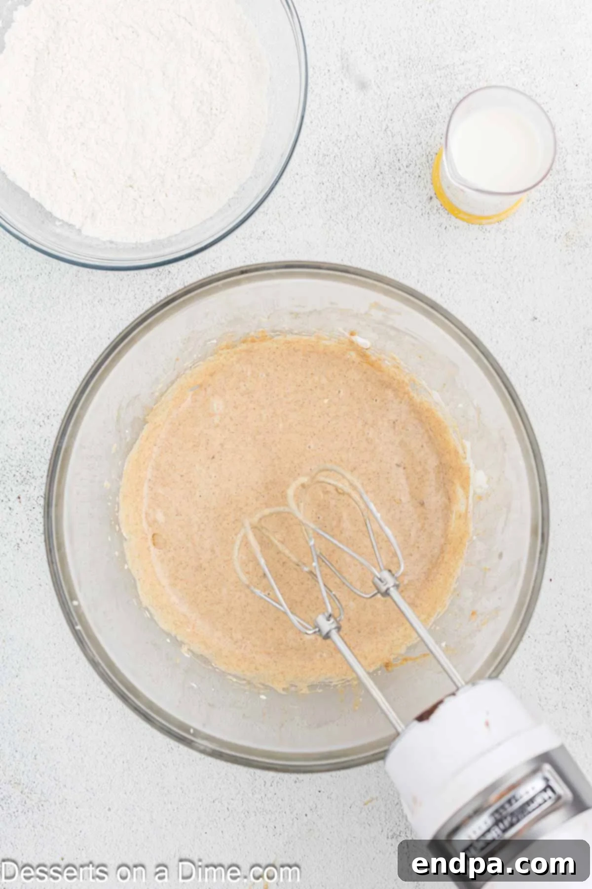Golden Spiced Churro Cake 6 Eggs being added one at a time to the cake batter.