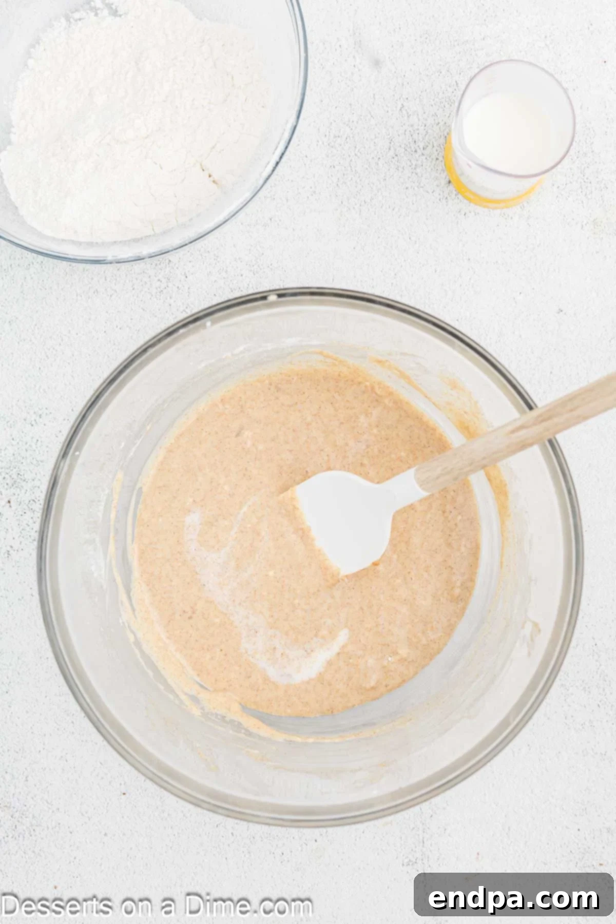 Golden Spiced Churro Cake 7 Sour cream and vanilla extract being combined into the cake batter.
