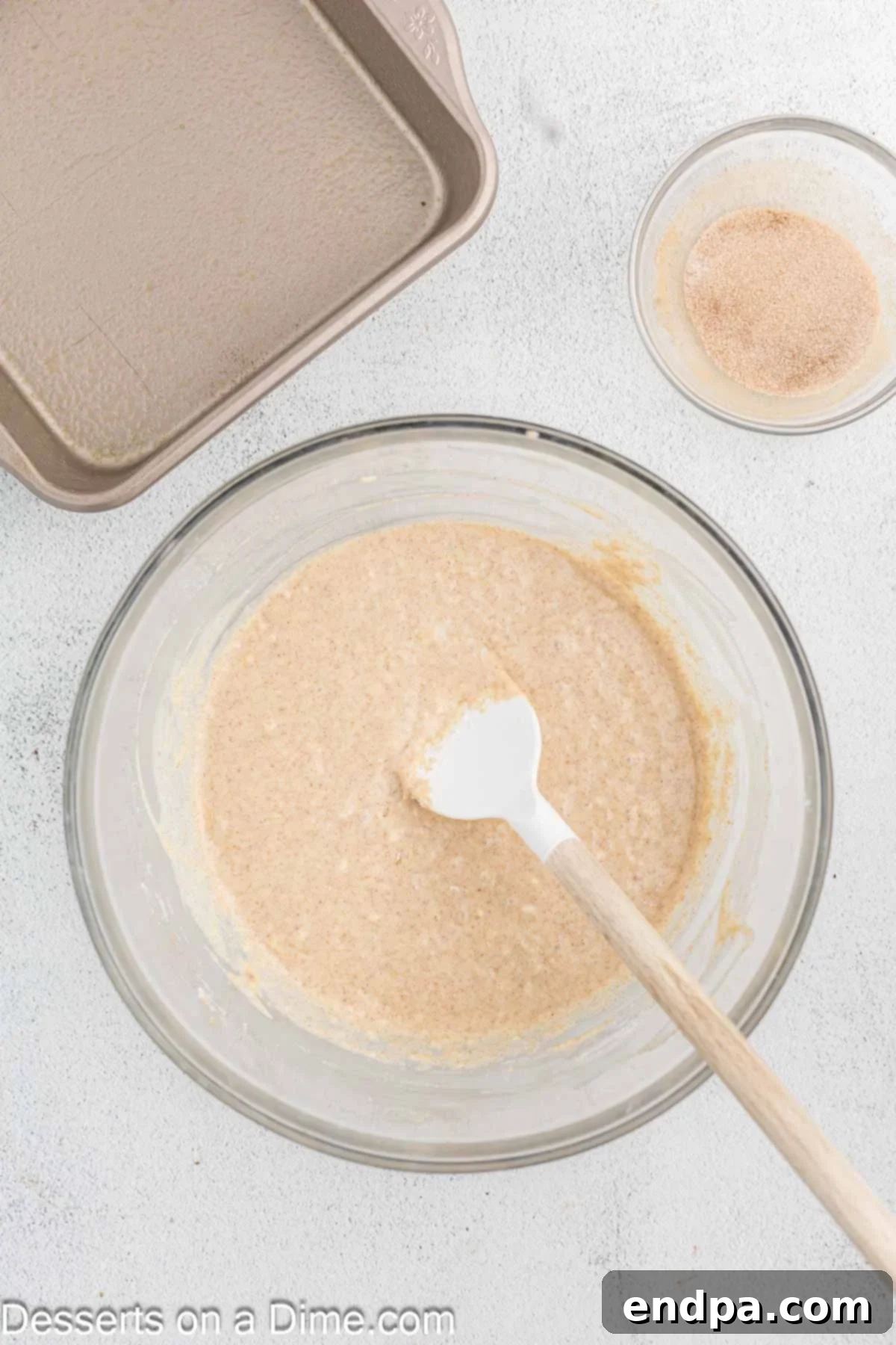 Golden Spiced Churro Cake 8 Dry ingredients being gently folded into the wet batter.