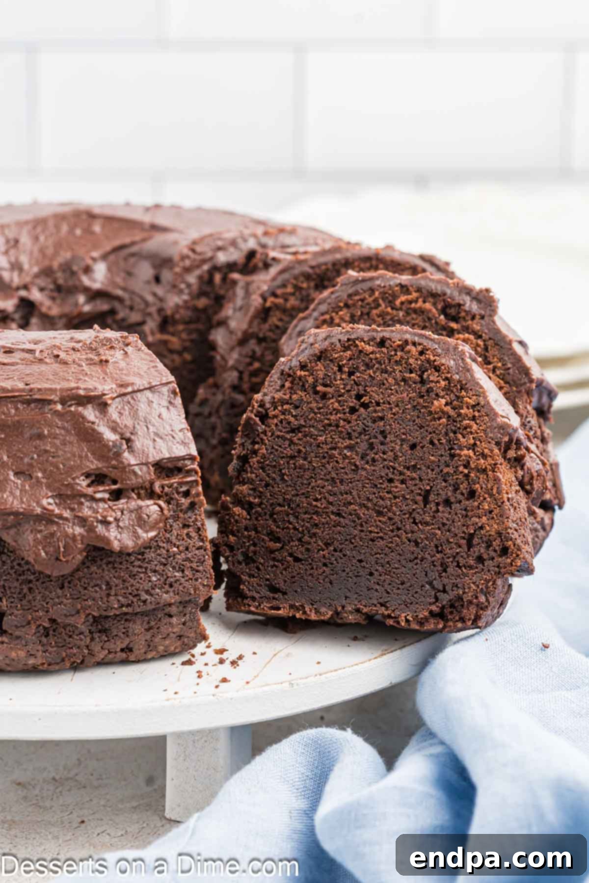 Velvet Chocolate Loaf 2 Slices of moist Chocolate Pound Cake adorned with rich chocolate frosting, ready to be enjoyed.
