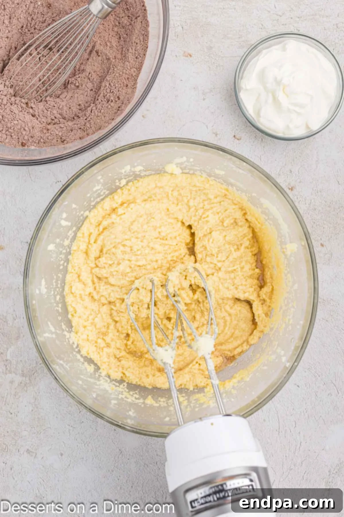 Velvet Chocolate Loaf 5 Room temperature eggs are gradually incorporated into the fluffy butter and sugar mixture, followed by vanilla extract and coffee.