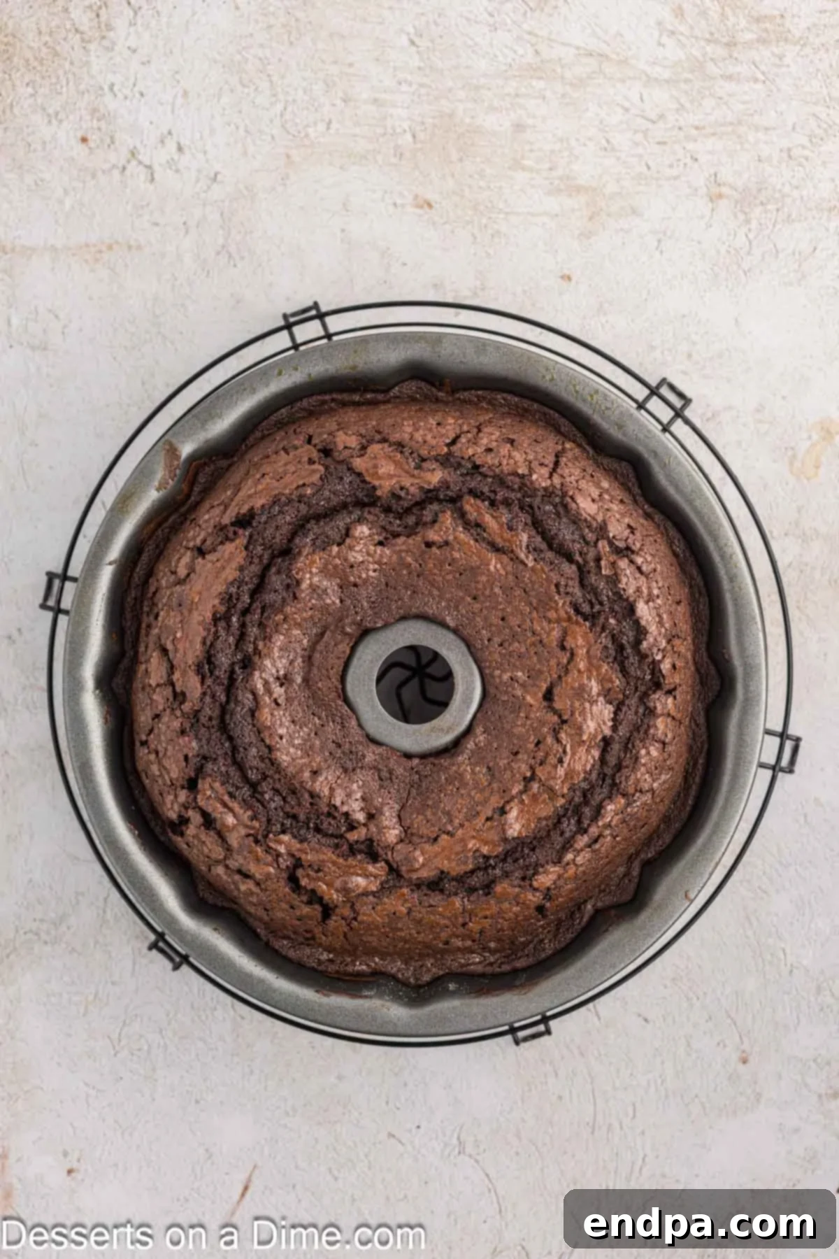 Velvet Chocolate Loaf 8 Baked Chocolate Pound Cake cooling in the bundt pan before being inverted onto a wire rack.