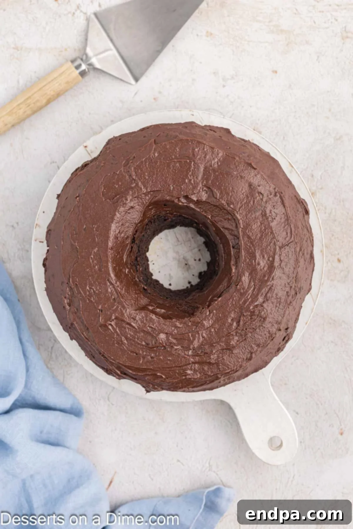Velvet Chocolate Loaf 10 The cooled Chocolate Pound Cake is generously covered with a smooth, glossy chocolate glaze on a serving platter.