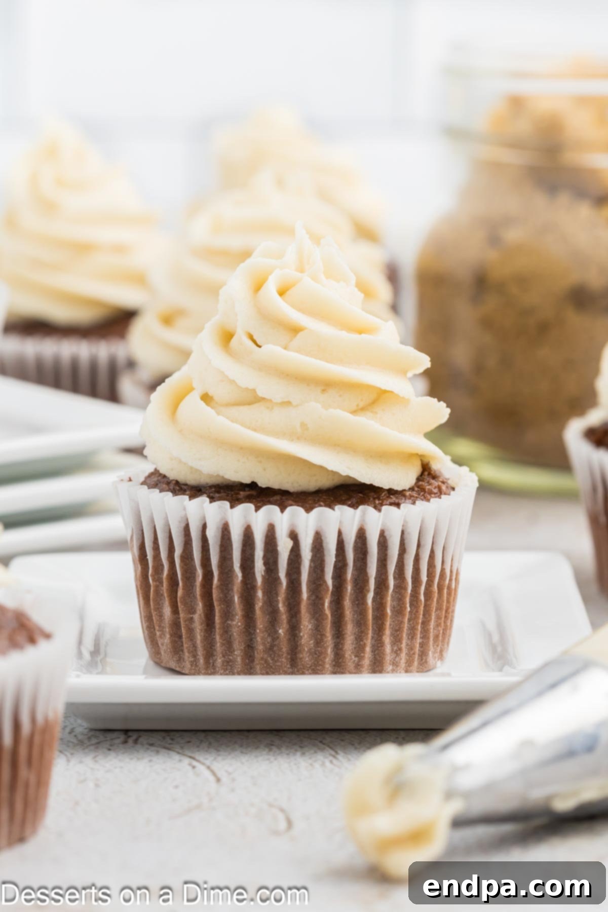 Golden Brown Sugar Buttercream 2 Delicate cupcake adorned with a swirl of rich, golden brown sugar frosting, ready to be enjoyed.