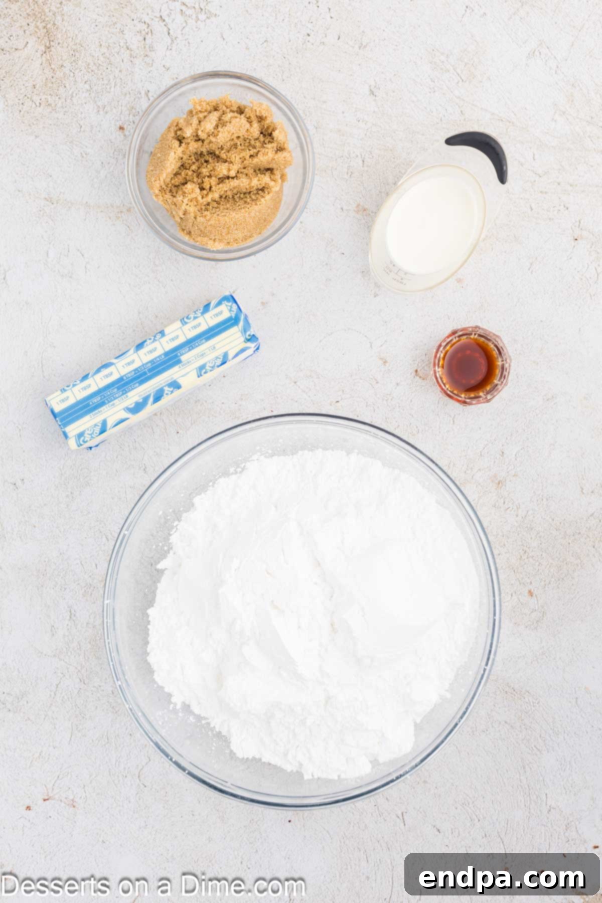 Golden Brown Sugar Buttercream 3 A visual display of the key ingredients needed for brown sugar frosting: softened butter, light brown sugar, pure vanilla extract, sifted powdered sugar, and heavy cream.