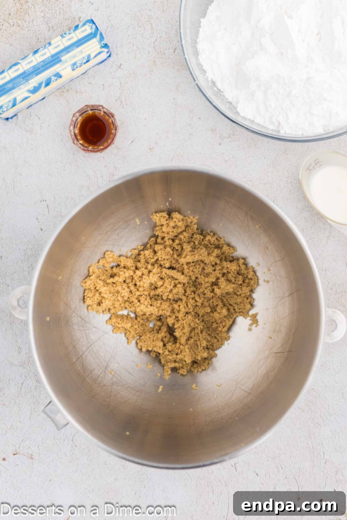 Golden Brown Sugar Buttercream 4 Loose light brown sugar in a stand mixer bowl, indicating the first step of preparation.