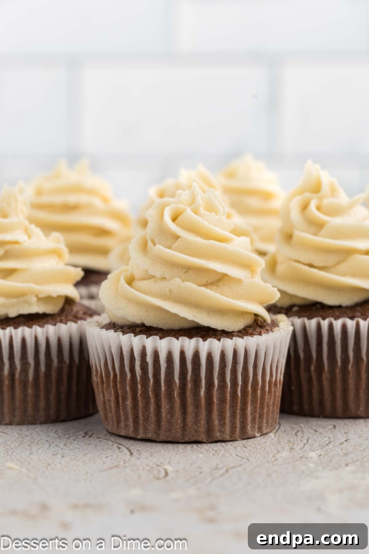 Golden Brown Sugar Buttercream 8 A delightful arrangement of cupcakes generously topped with fluffy brown sugar frosting, enticingly ready for serving.