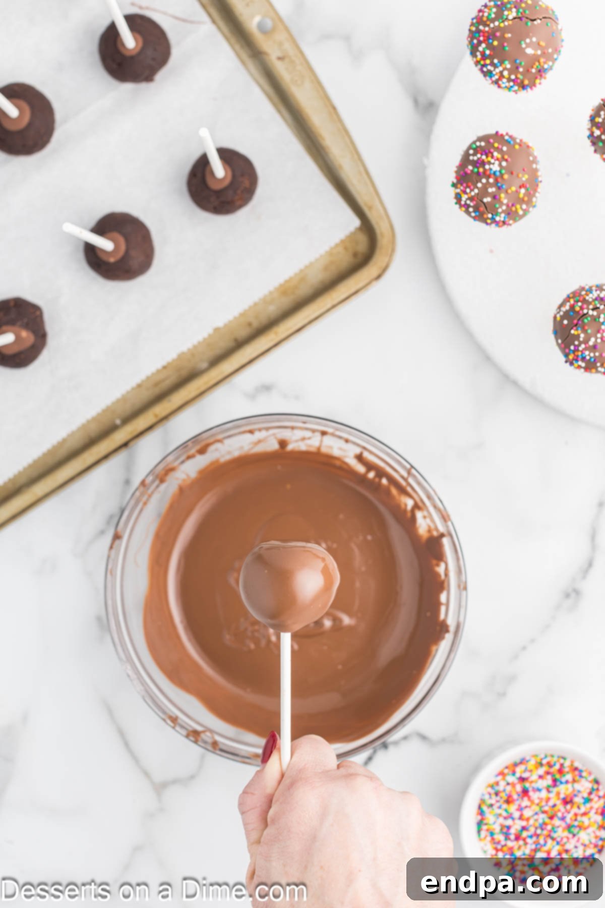 Bite Sized Chocolate Bliss 12 A chocolate cake pop being dipped into a bowl of melted chocolate candy melts, ensuring a smooth, even coating.