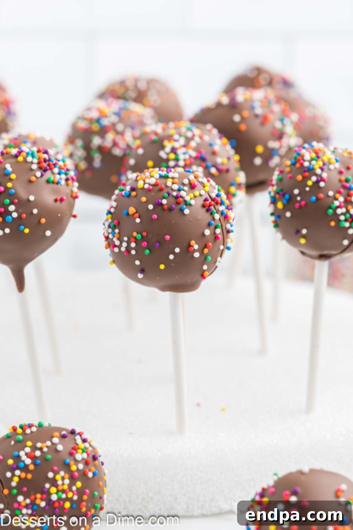 Bite Sized Chocolate Bliss 14 A cluster of beautifully decorated chocolate cake pops with colorful sprinkles, showcasing their festive appeal.