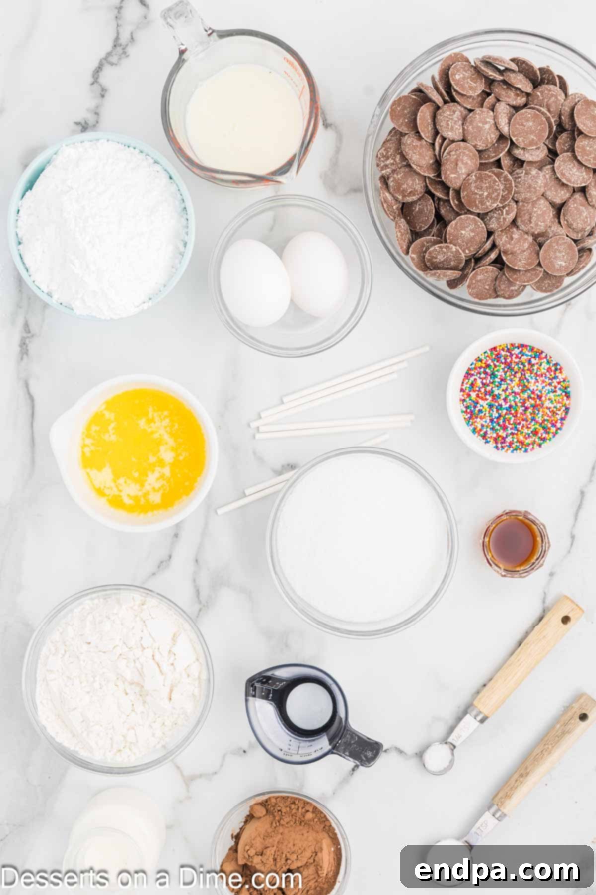 Bite Sized Chocolate Bliss 3 A flat lay image showing the key ingredients for chocolate cake pops: all-purpose flour, granulated sugar, unsweetened cocoa powder, baking soda, butter, eggs, vanilla extract, and buttermilk.