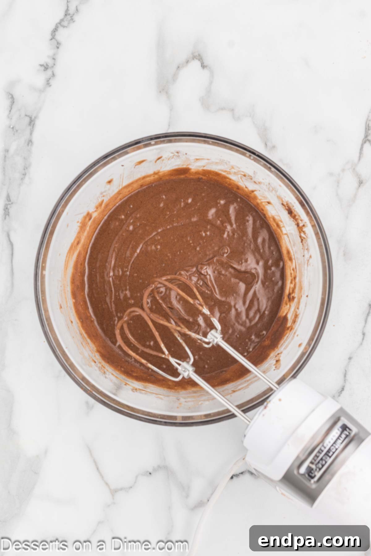 Bite Sized Chocolate Bliss 5 Buttermilk and hot water being mixed into the chocolate cake batter on low speed.