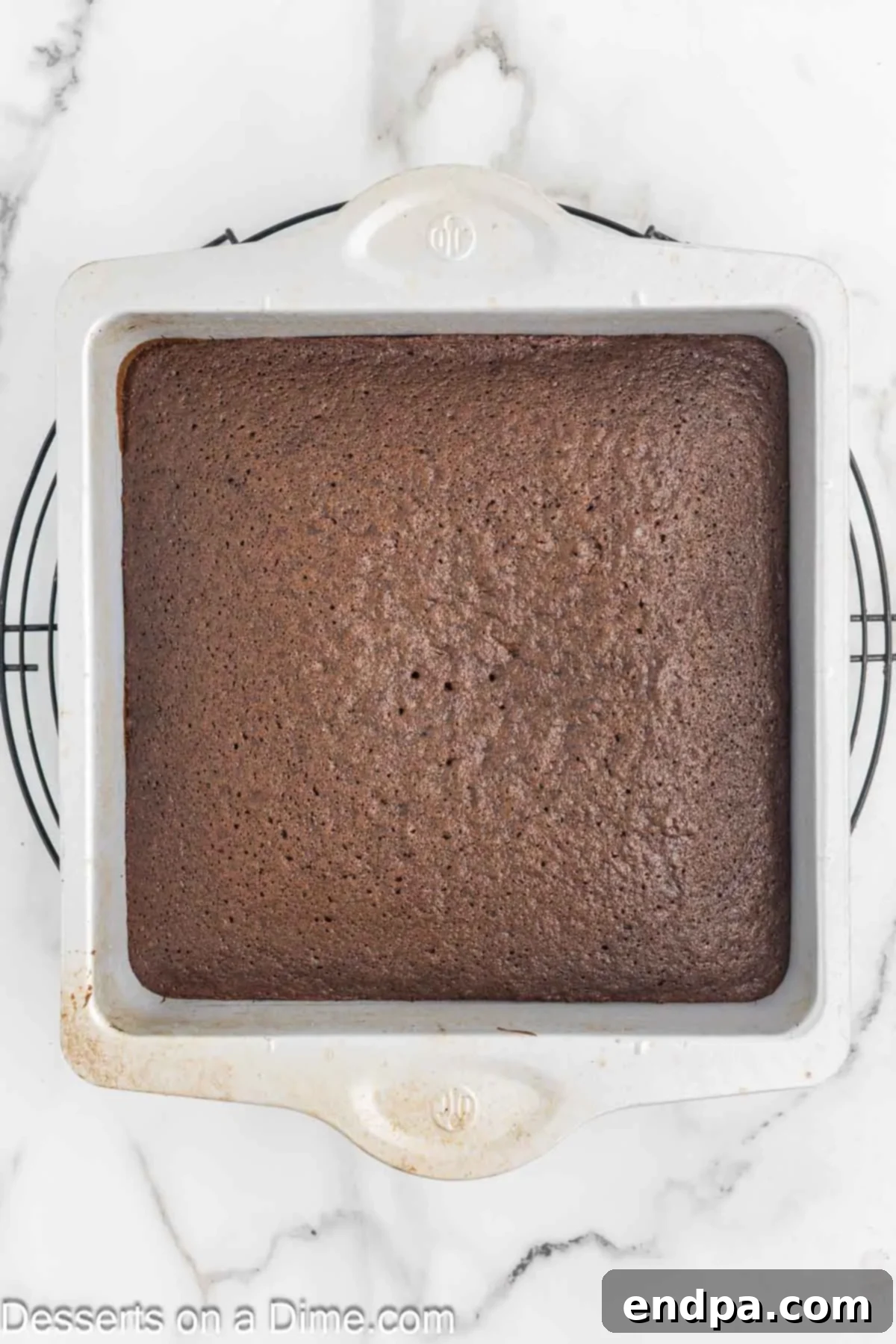 Bite Sized Chocolate Bliss 6 A freshly baked chocolate cake cooling on a wire rack in a kitchen setting.