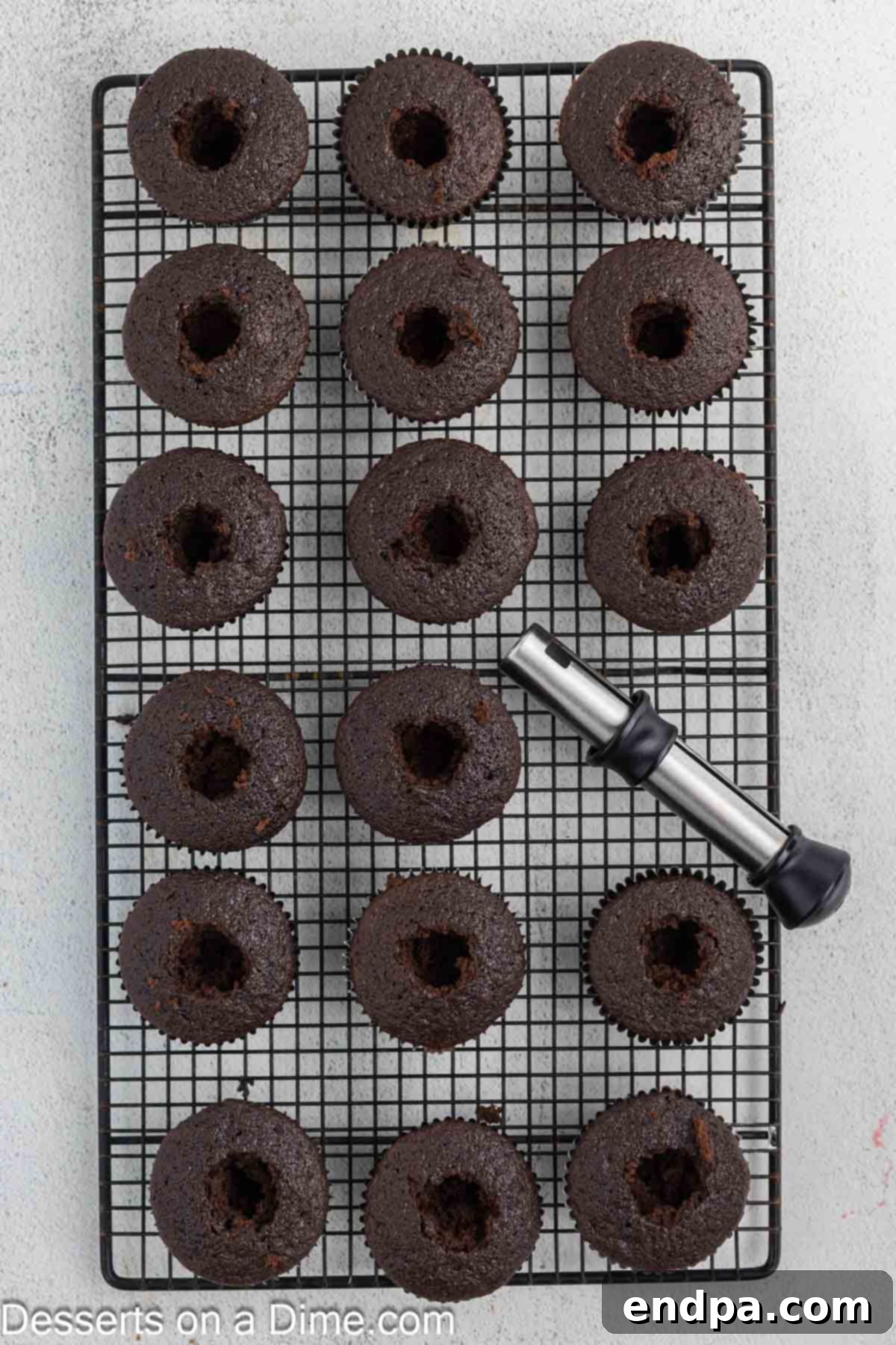 A cupcake with its center carefully removed, ready for filling.