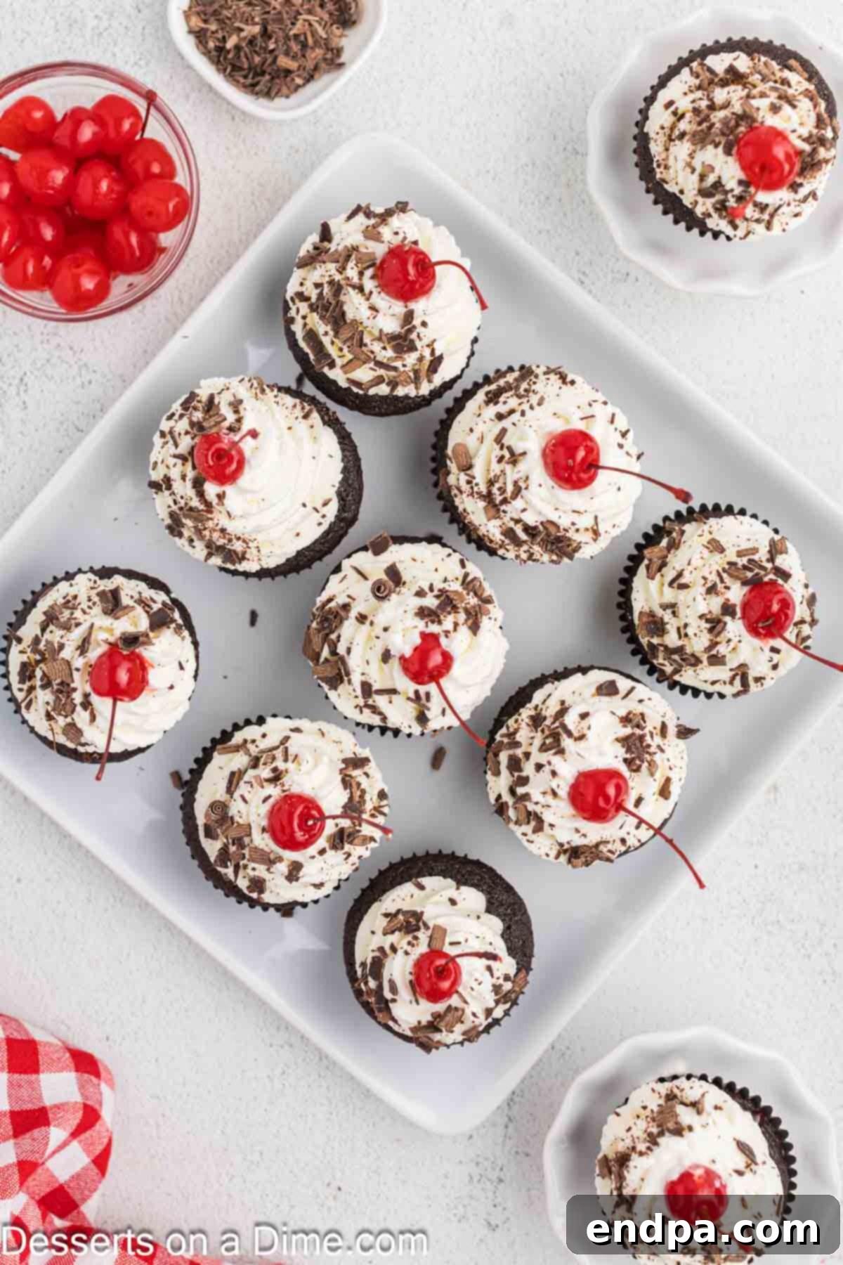 Finished Black Forest Cupcakes arranged beautifully on a platter, garnished with cherries and chocolate.