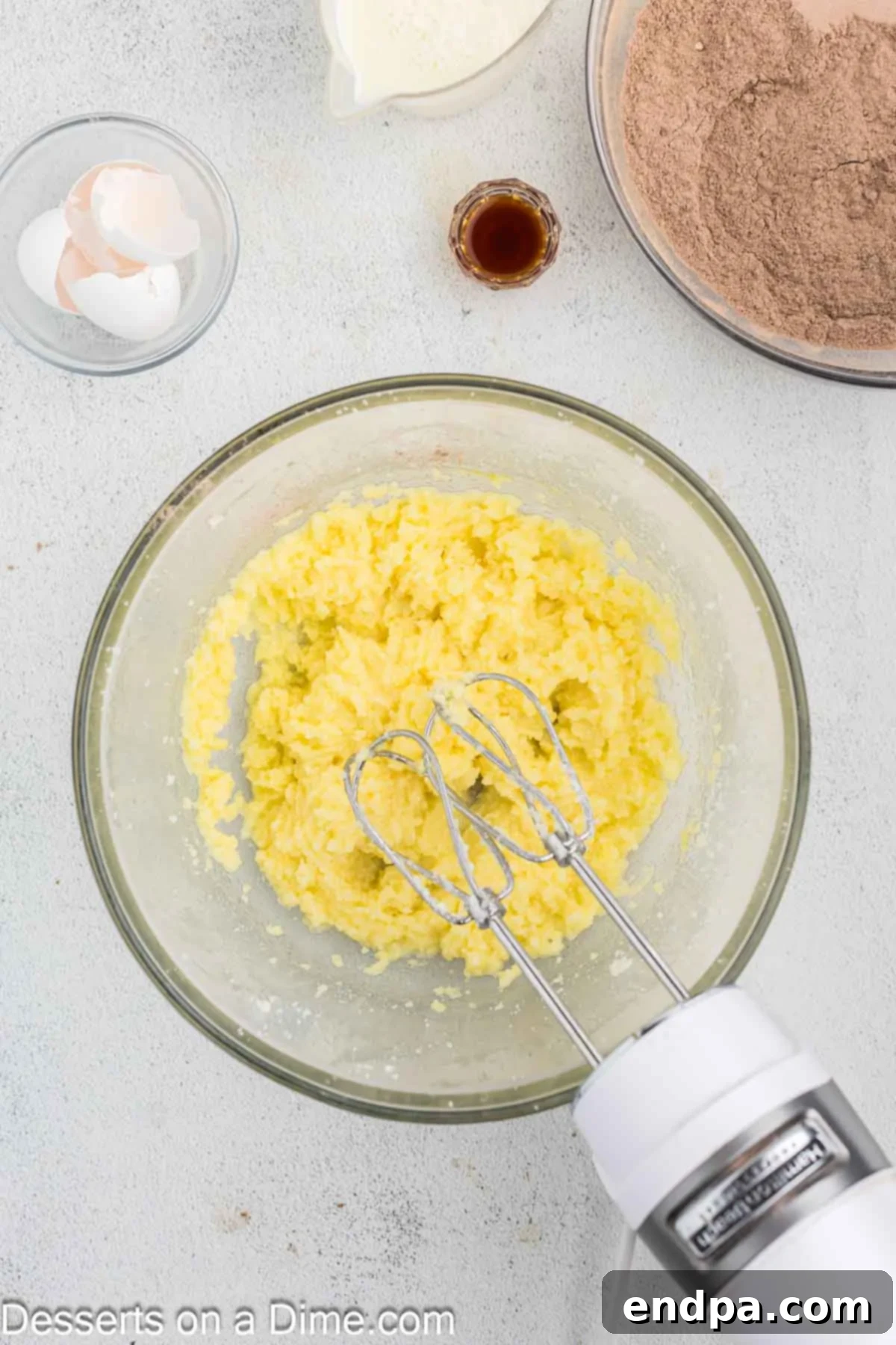 Eggs being mixed into the creamed butter and sugar mixture.