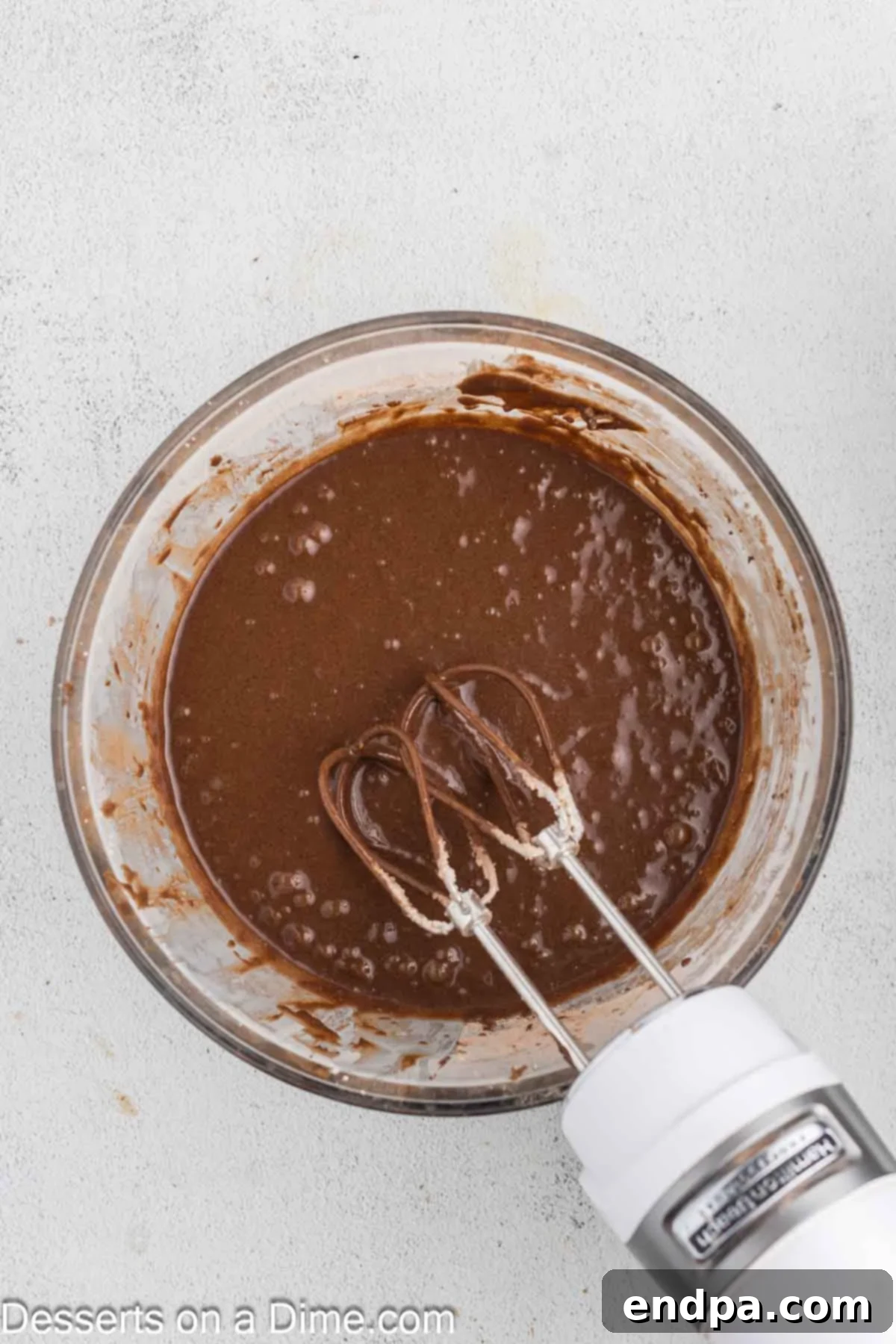 Smooth cupcake batter combined in a bowl, ready for baking.