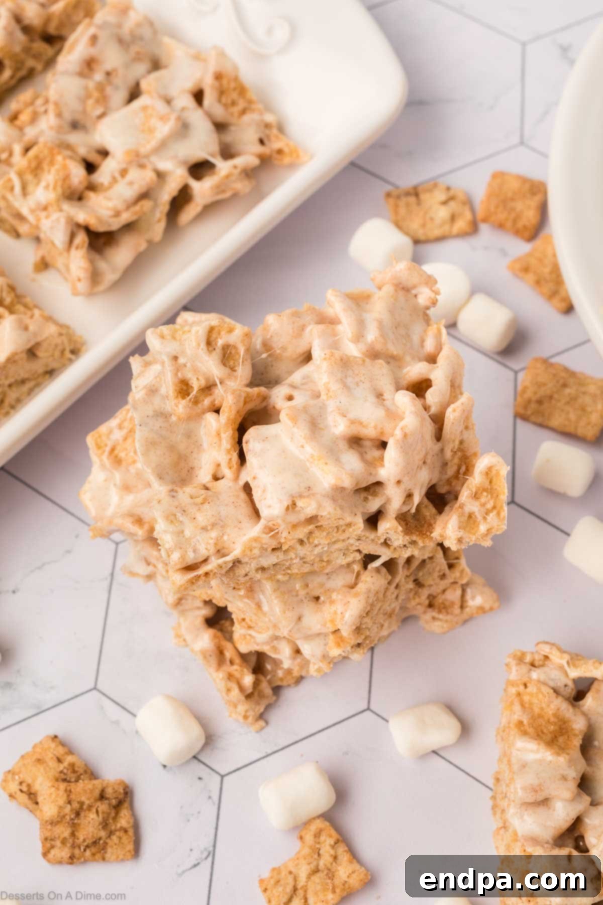 Cinnamon Toast Crunch Bars stacked together on a plate, showcasing their sweet, gooey texture.