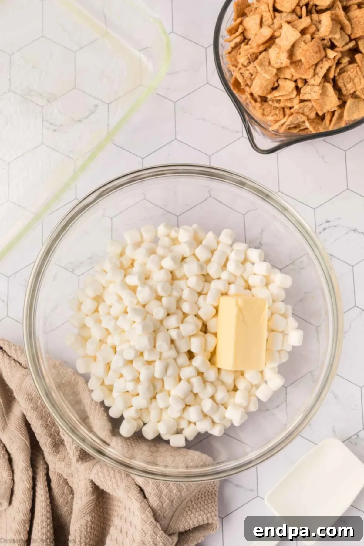 Mixing bowl with mini marshmallows and salted butter, ready to be melted in the microwave.